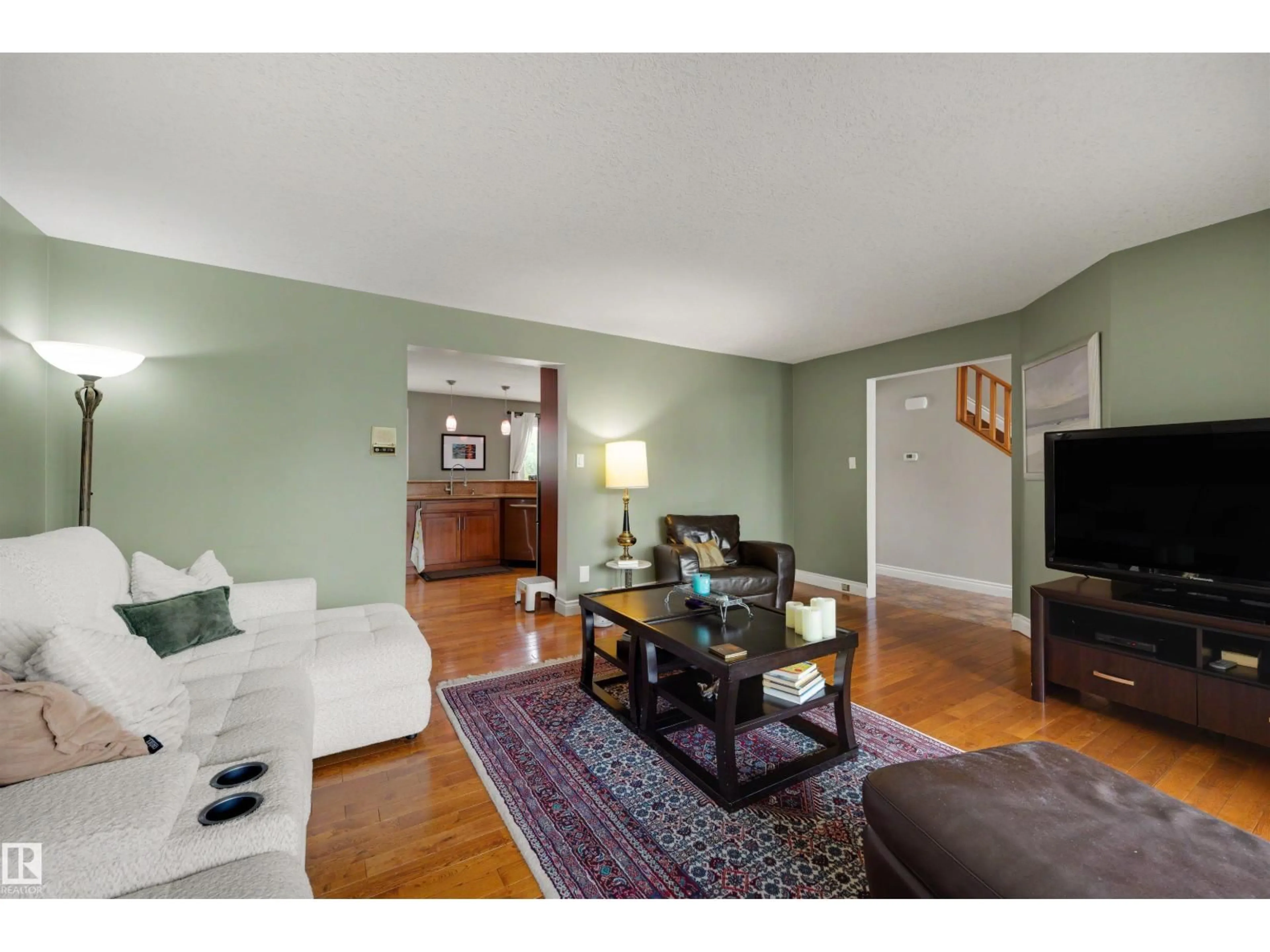 Living room with furniture, wood/laminate floor for NW - 11233 34A AV, Edmonton Alberta T6J3M4