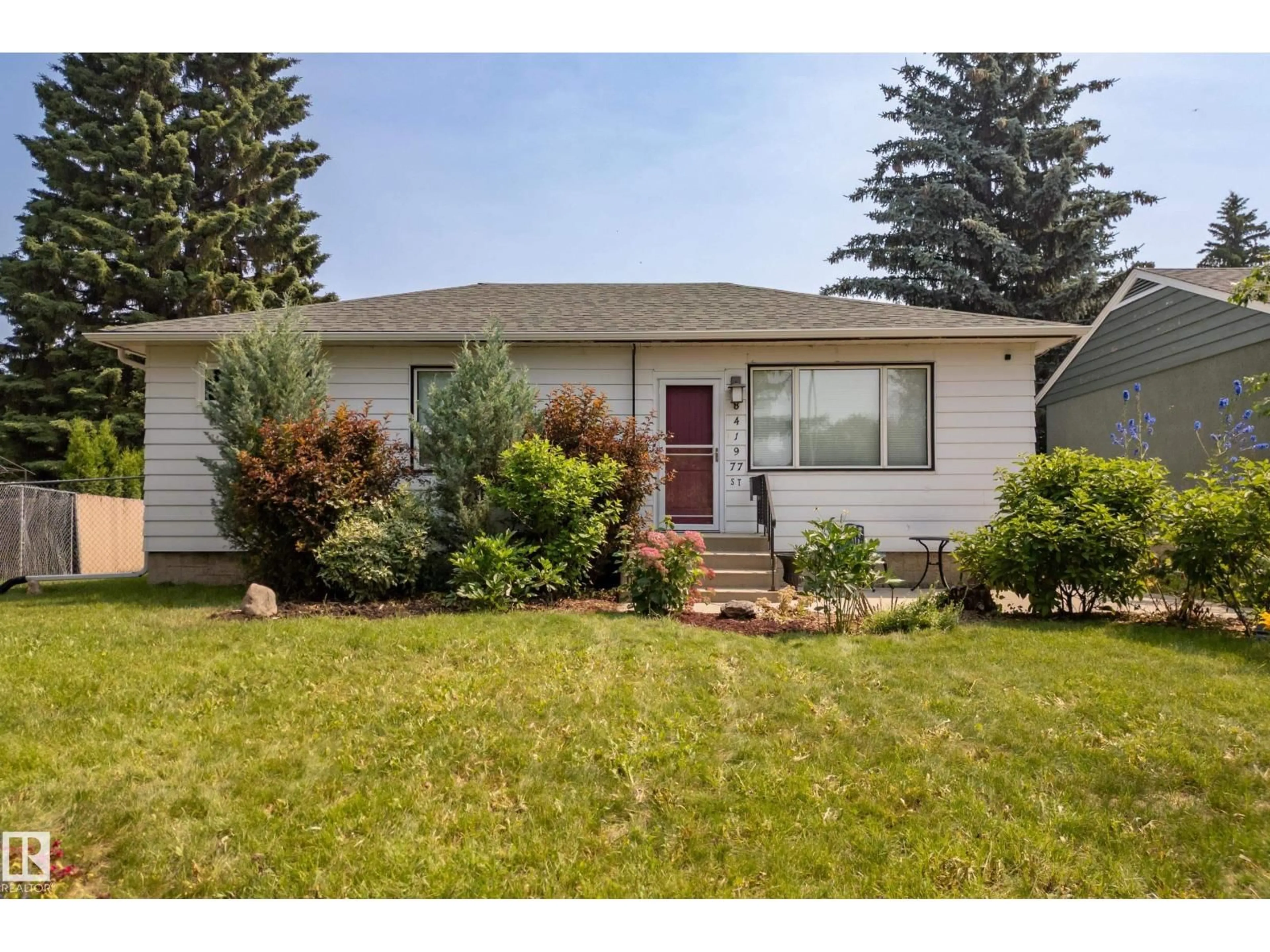 Home with vinyl exterior material, street for 8419 77 ST, Edmonton Alberta T6C2L7