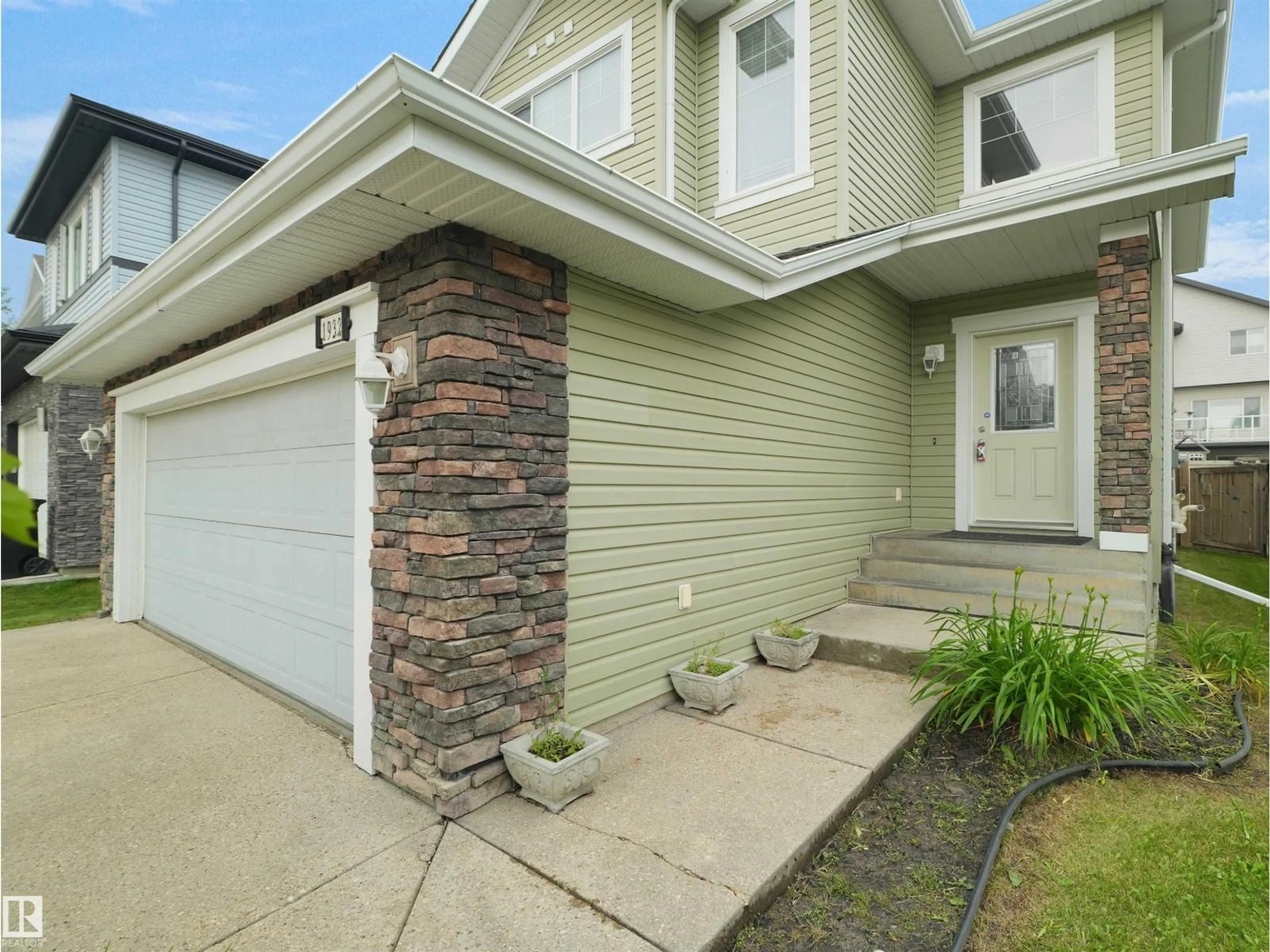 Home with vinyl exterior material, street for SW - 1932 67 ST, Edmonton Alberta T6X0L9