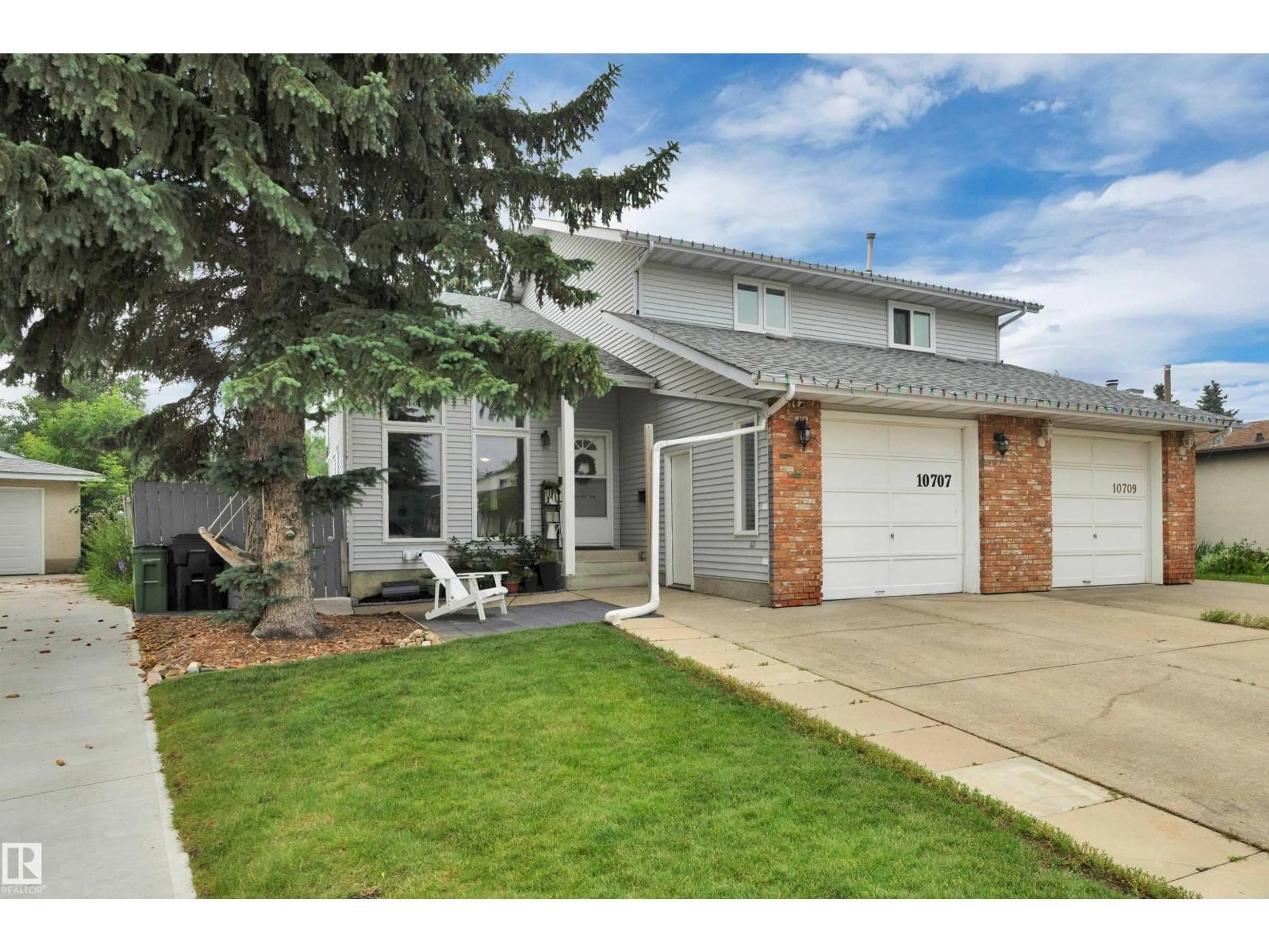 Home with vinyl exterior material, street for NW - 10707 24 AV, Edmonton Alberta T6J5P9