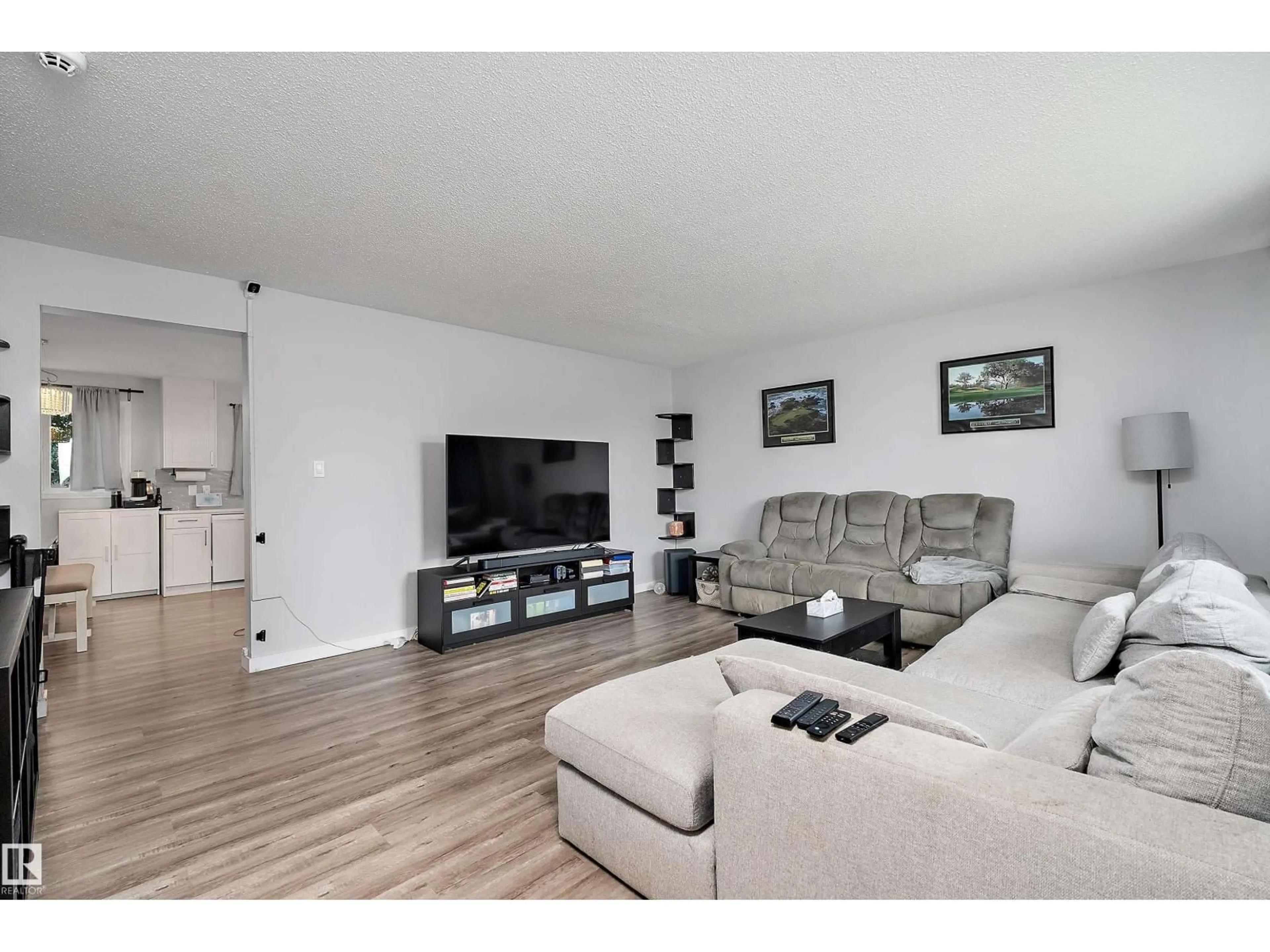 Living room with furniture, wood/laminate floor for 11439 39 AV, Edmonton Alberta T6J0M5