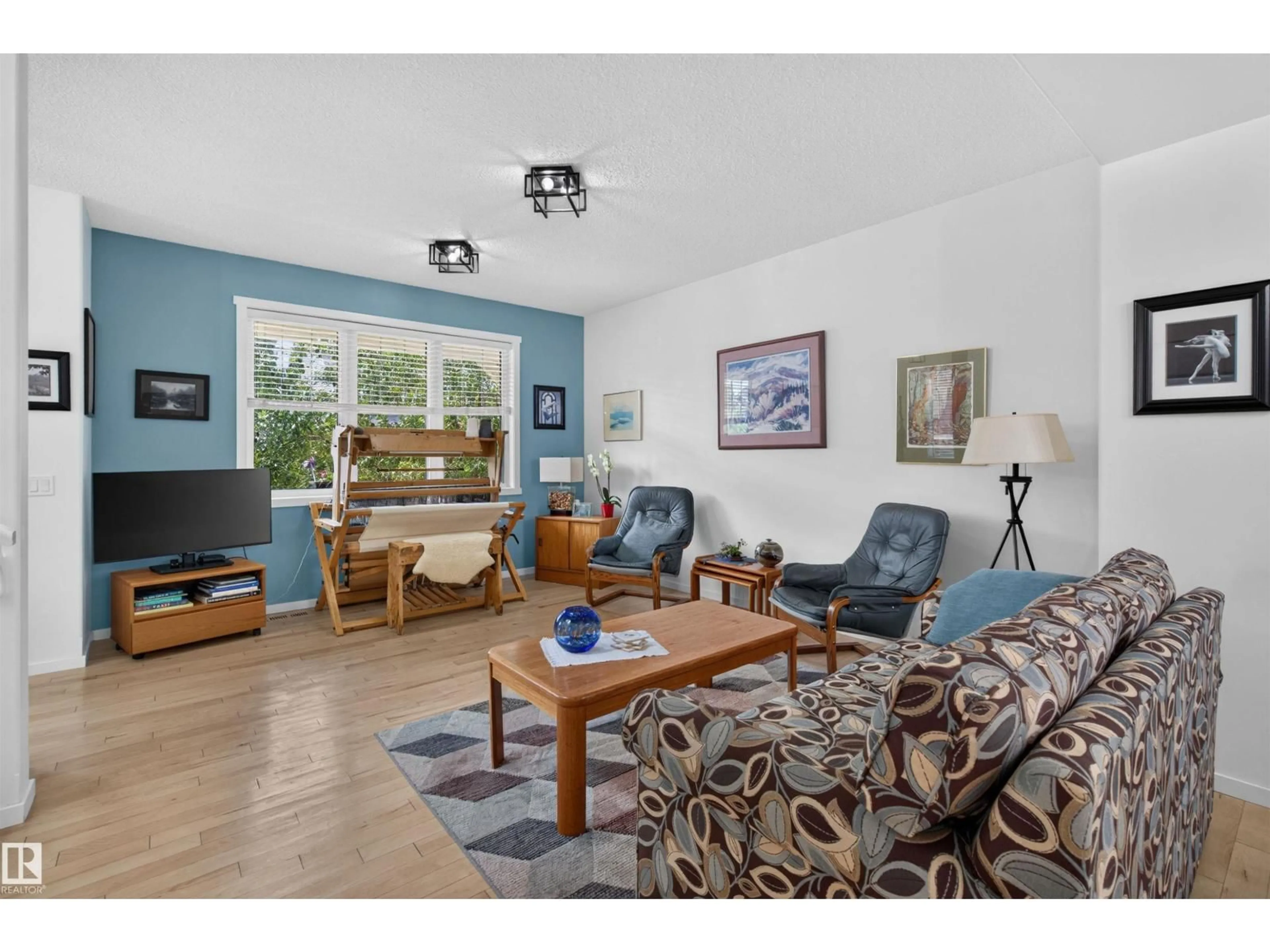 Living room with furniture, wood/laminate floor for 4065 MORRISON WY, Edmonton Alberta T5E6S3