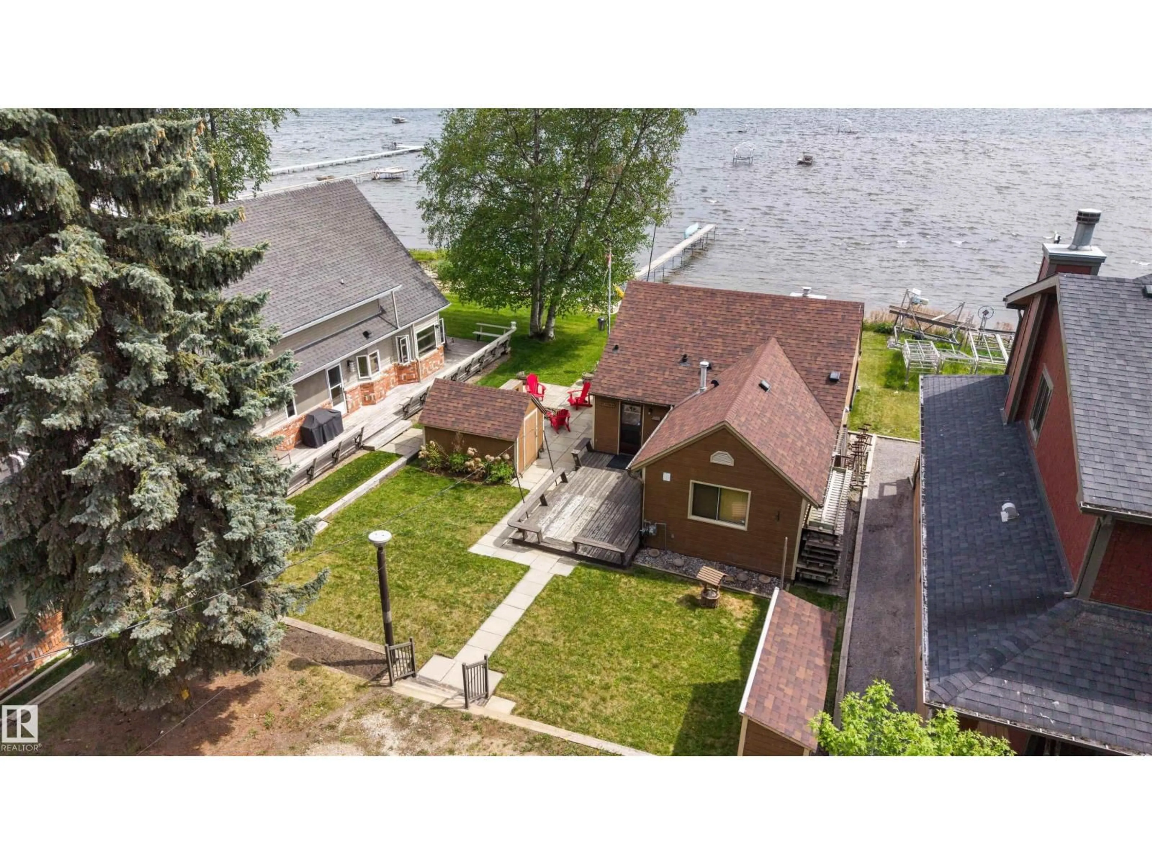 A pic from outside/outdoor area/front of a property/back of a property/a pic from drone, water/lake/river/ocean view for 595 1 AV, Rural Parkland County Alberta T0E2B0