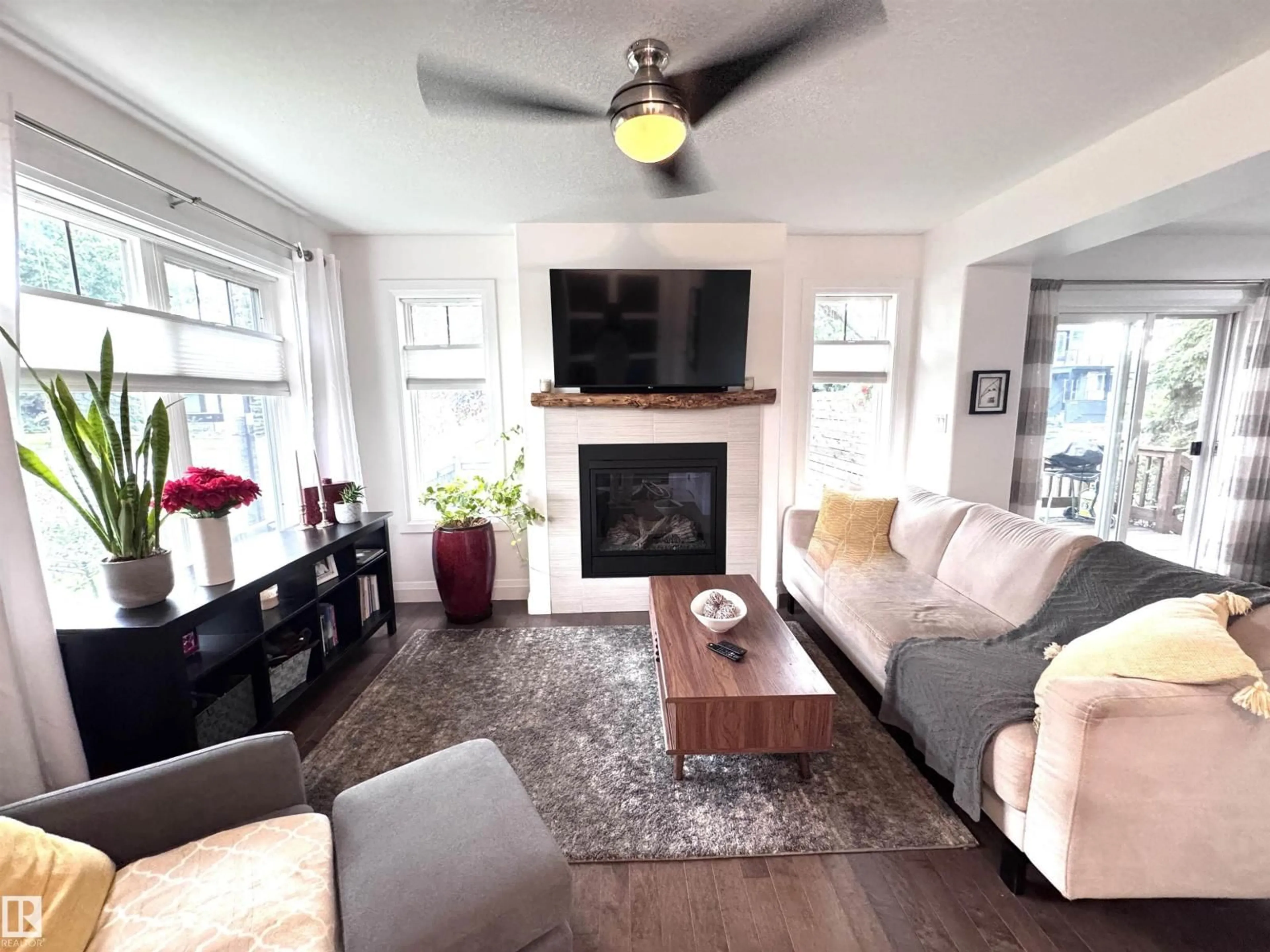 Living room with furniture, wood/laminate floor for NW - 7004 97 ST, Edmonton Alberta T6E3K1