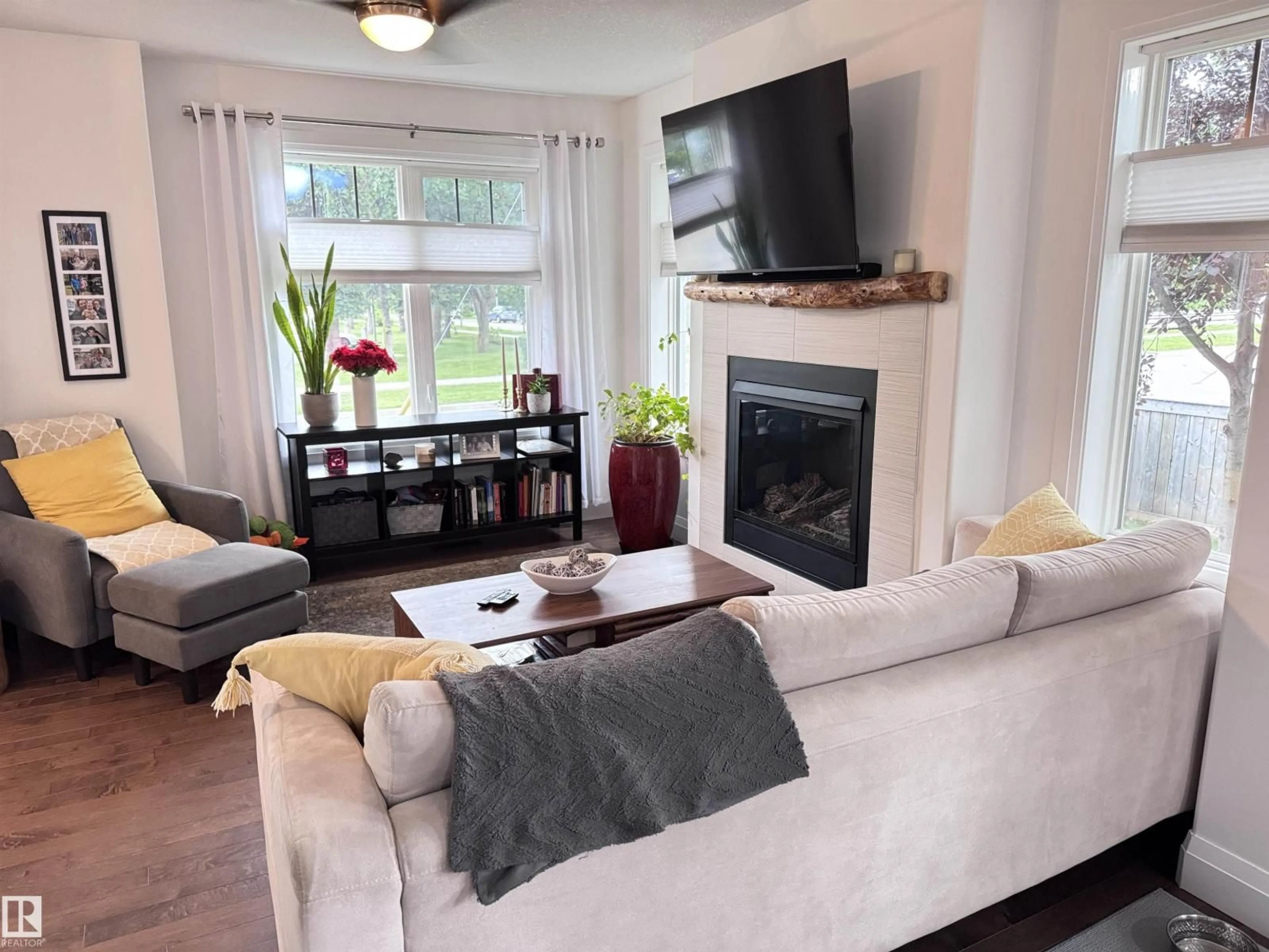 Living room with furniture, wood/laminate floor for NW - 7004 97 ST, Edmonton Alberta T6E3K1