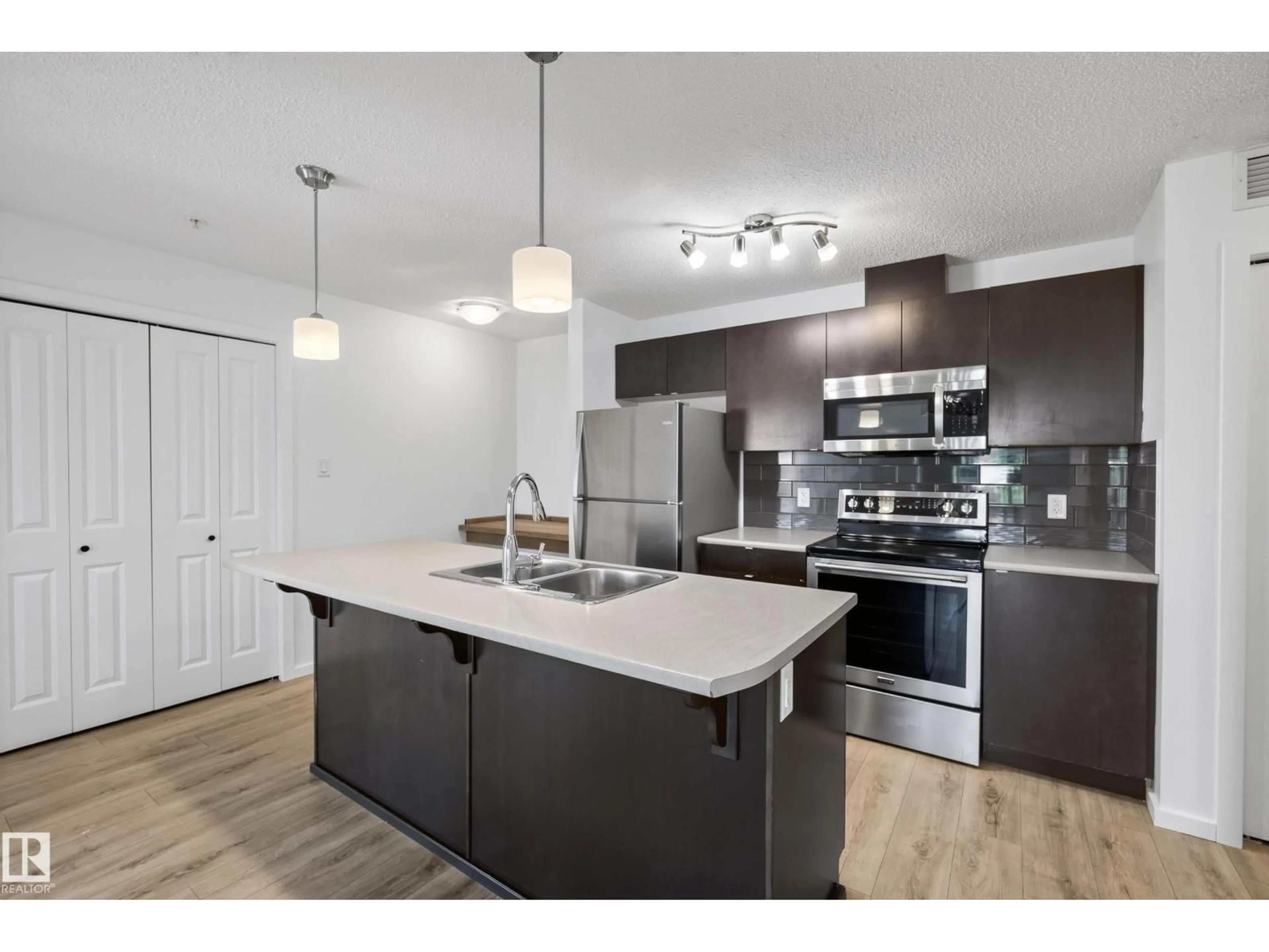 Open concept kitchen, wood/laminate floor for #319 - 508 ALBANY WY, Edmonton Alberta T6V0L1