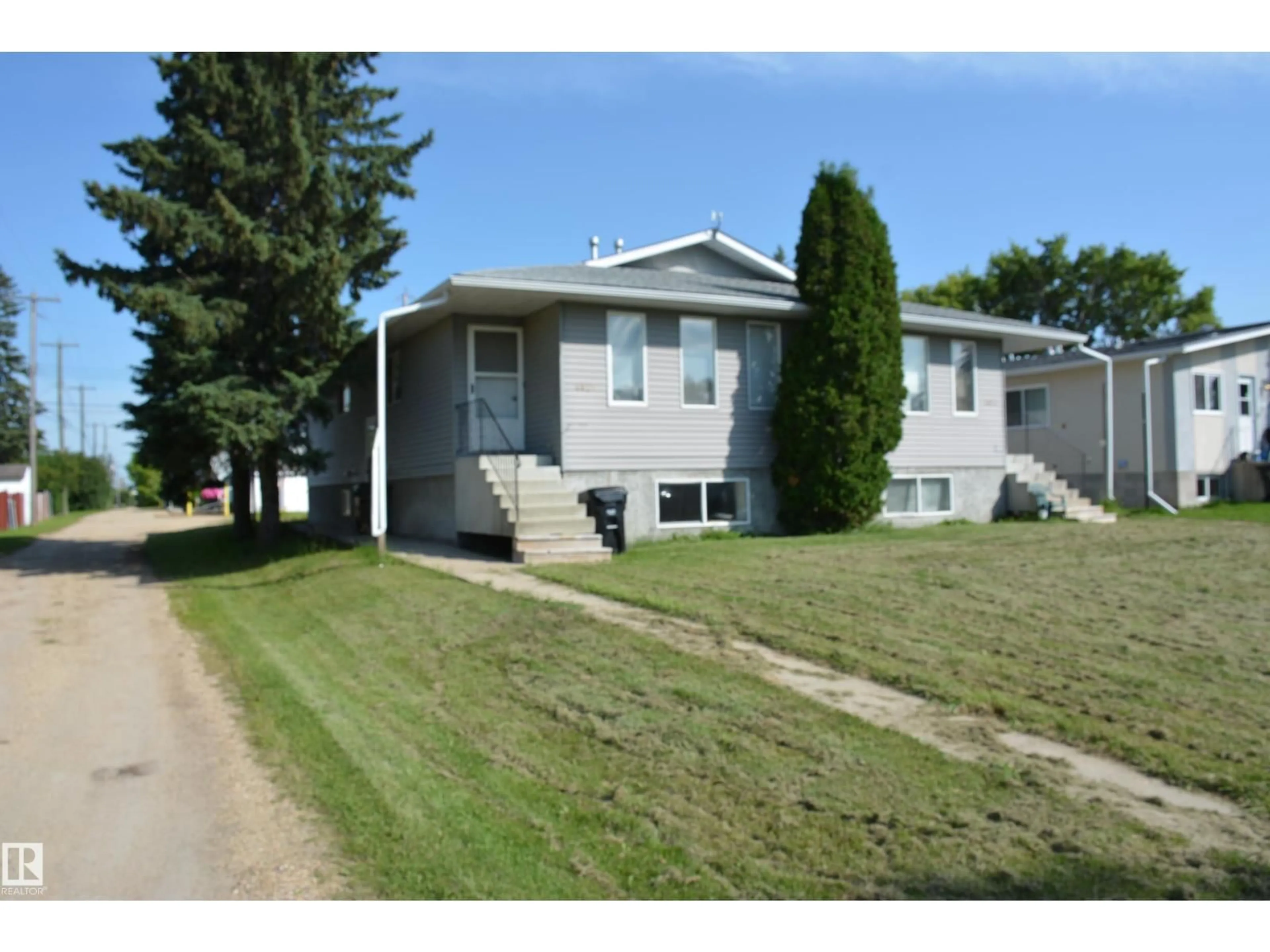 Home with vinyl exterior material, street for 4823 & 4825 52 ST, Barrhead Alberta T7N1G3