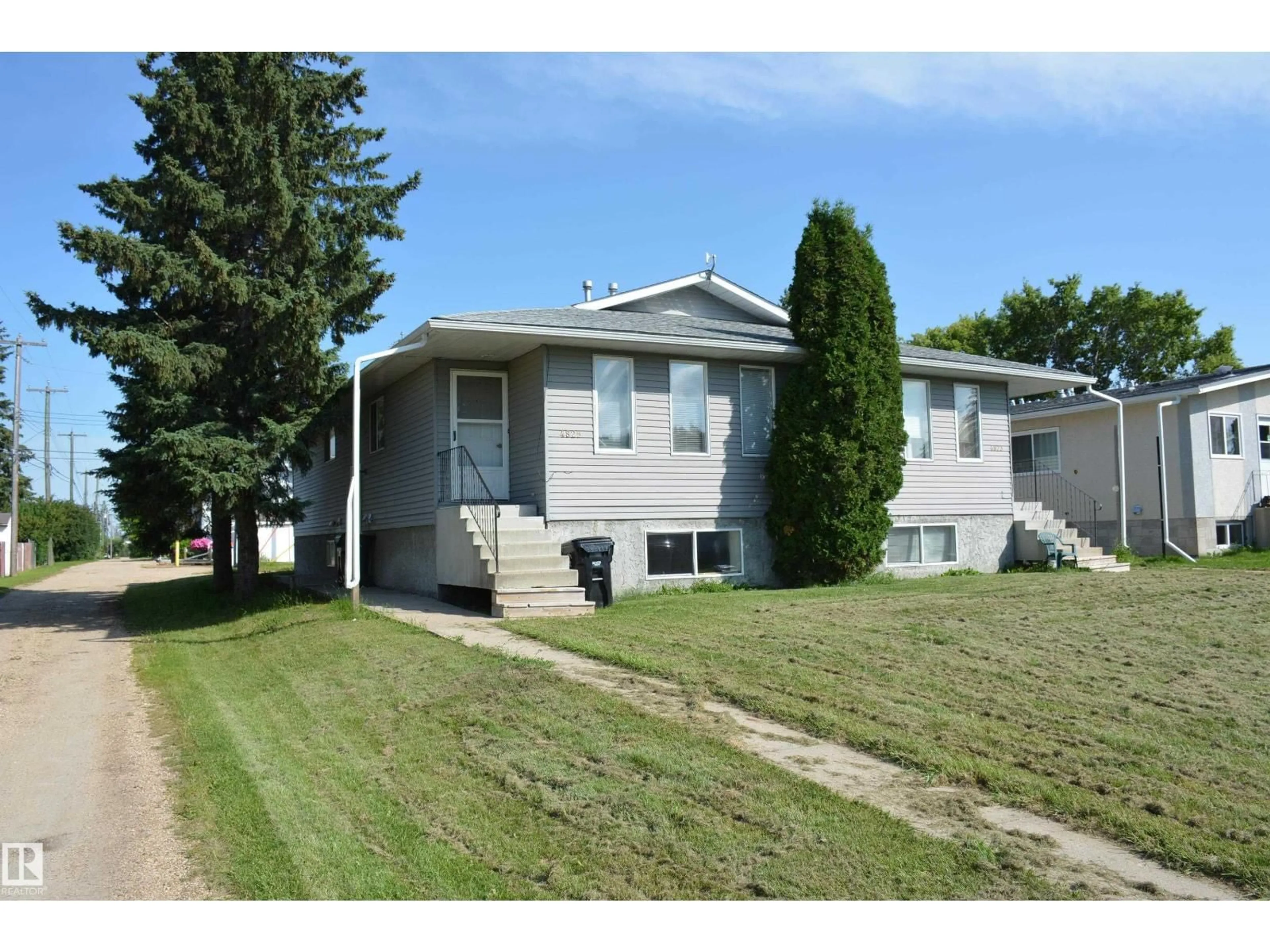 Home with vinyl exterior material, street for 4823 & 4825 52 ST, Barrhead Alberta T7N1G3
