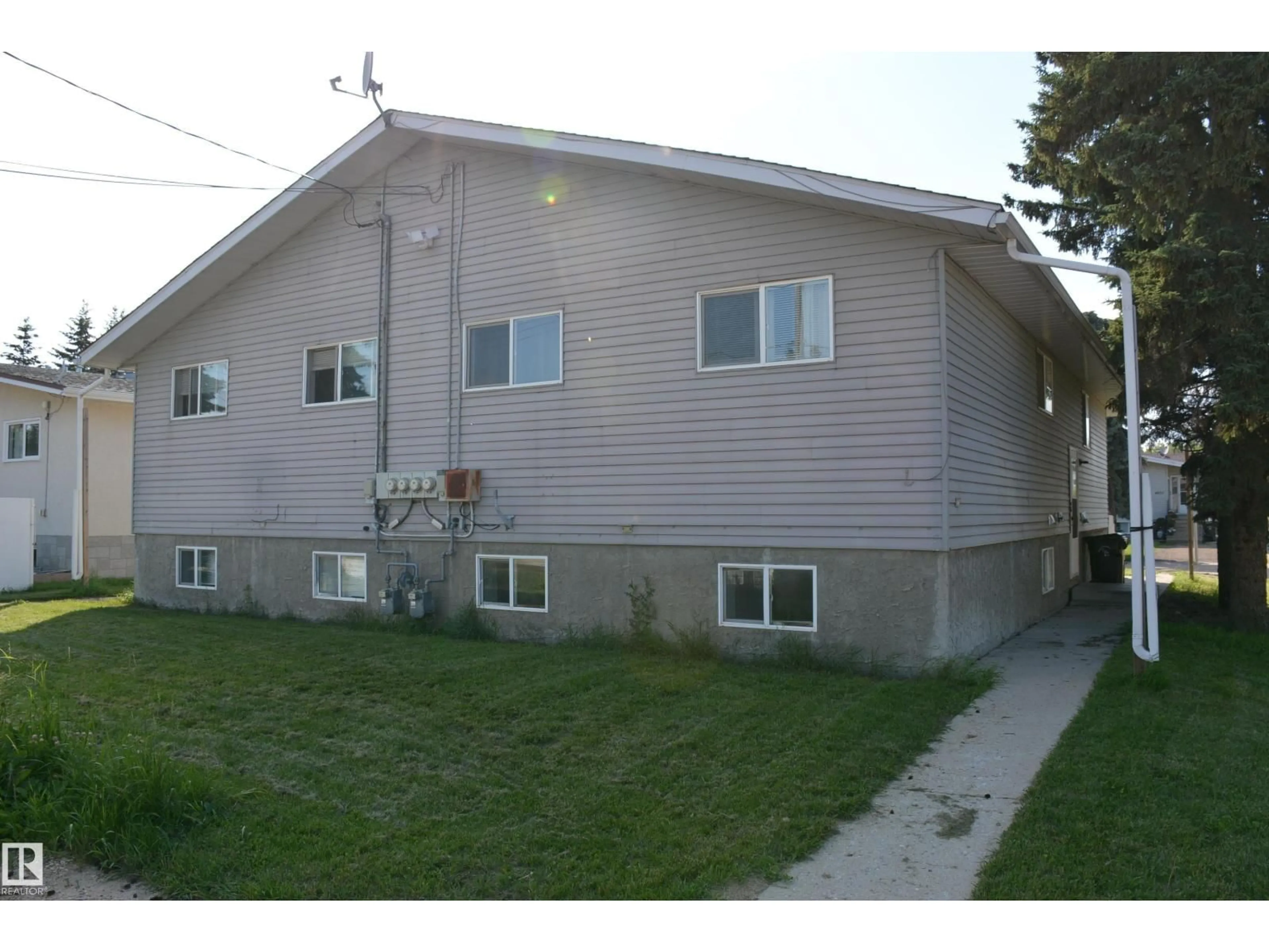 Home with vinyl exterior material, street for 4823 & 4825 52 ST, Barrhead Alberta T7N1G3