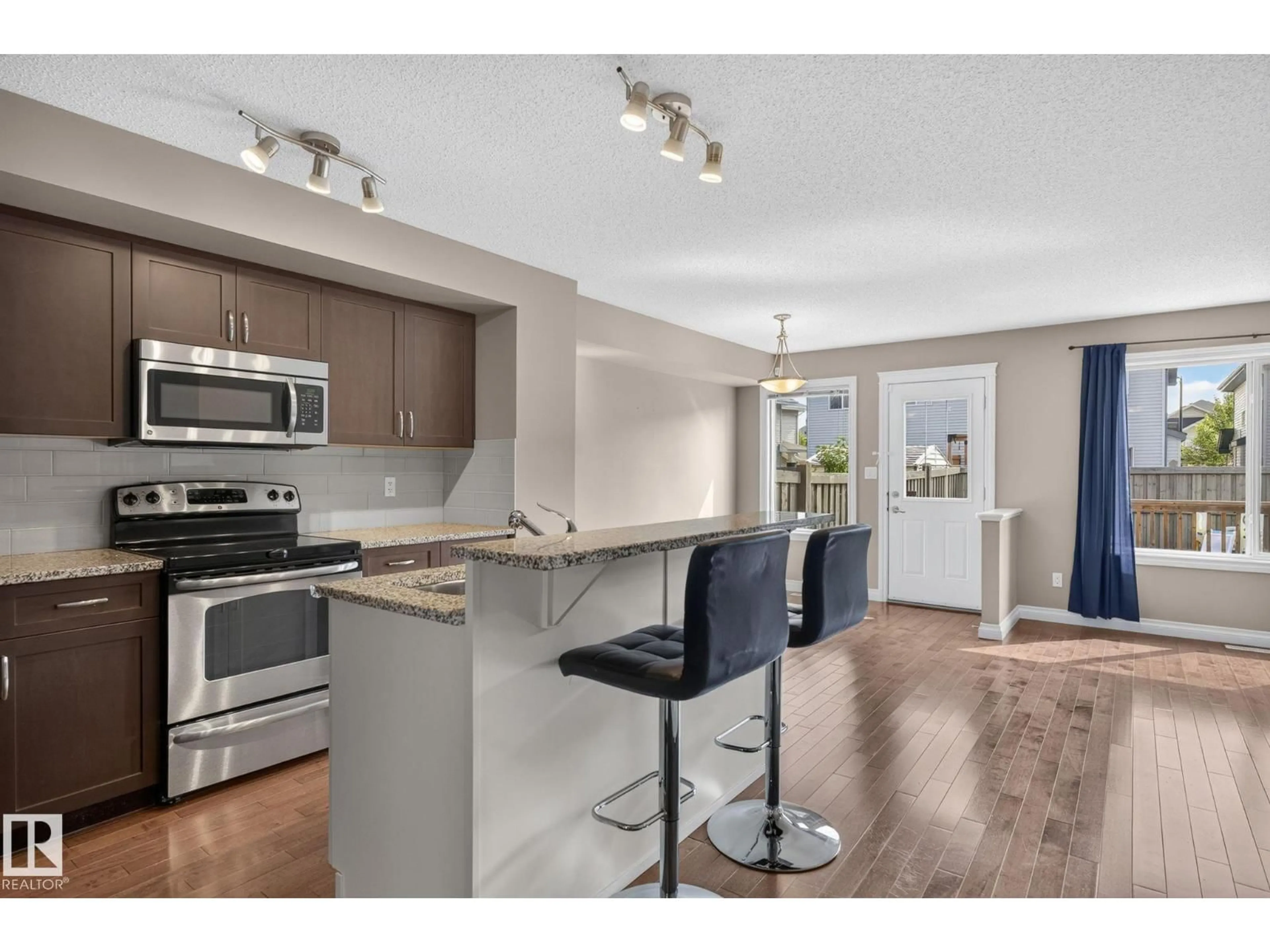 Open concept kitchen, wood/laminate floor for SW - 1107 177 ST, Edmonton Alberta T6W1Z9