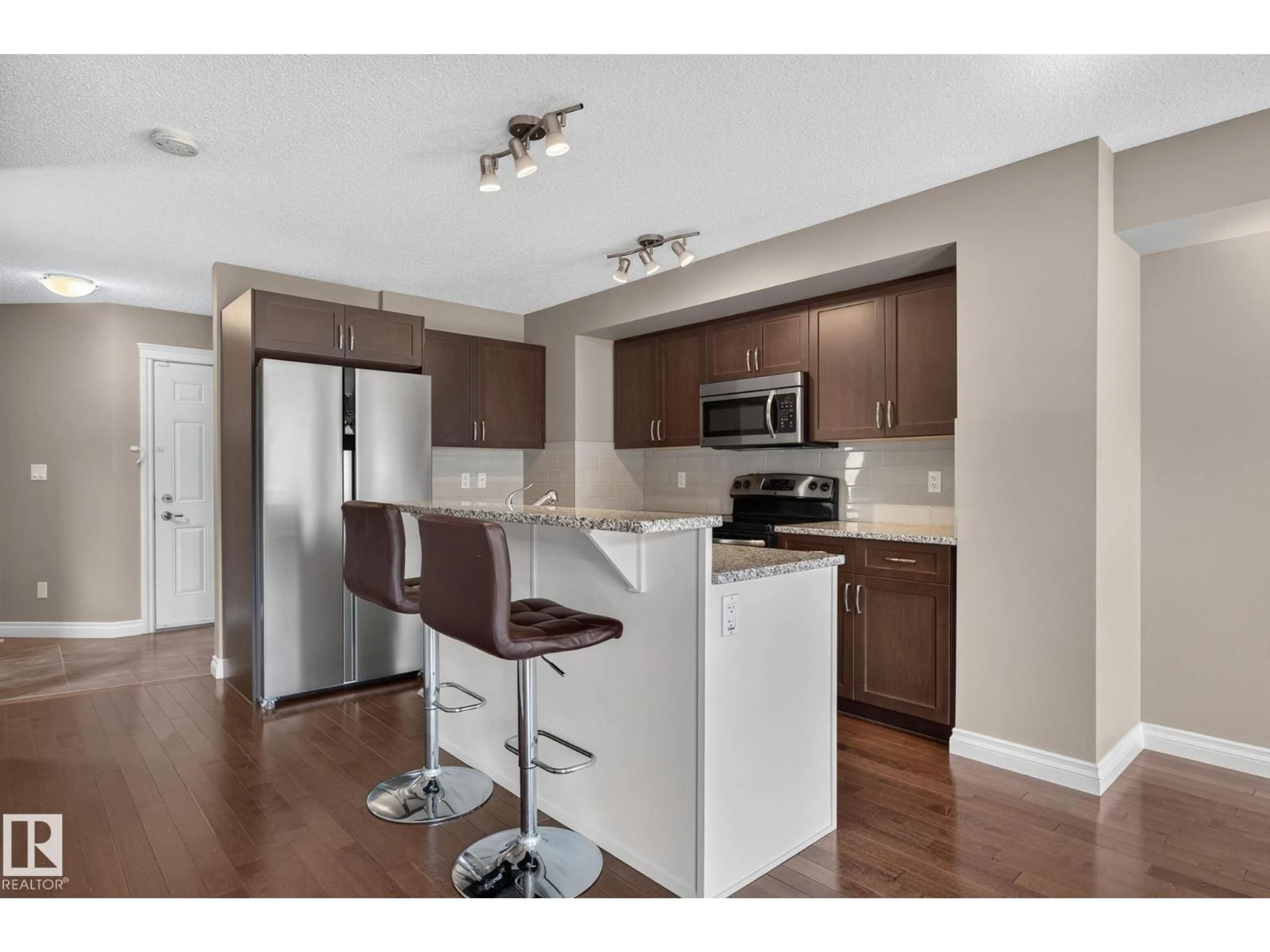 Open concept kitchen, wood/laminate floor for SW - 1107 177 ST, Edmonton Alberta T6W1Z9