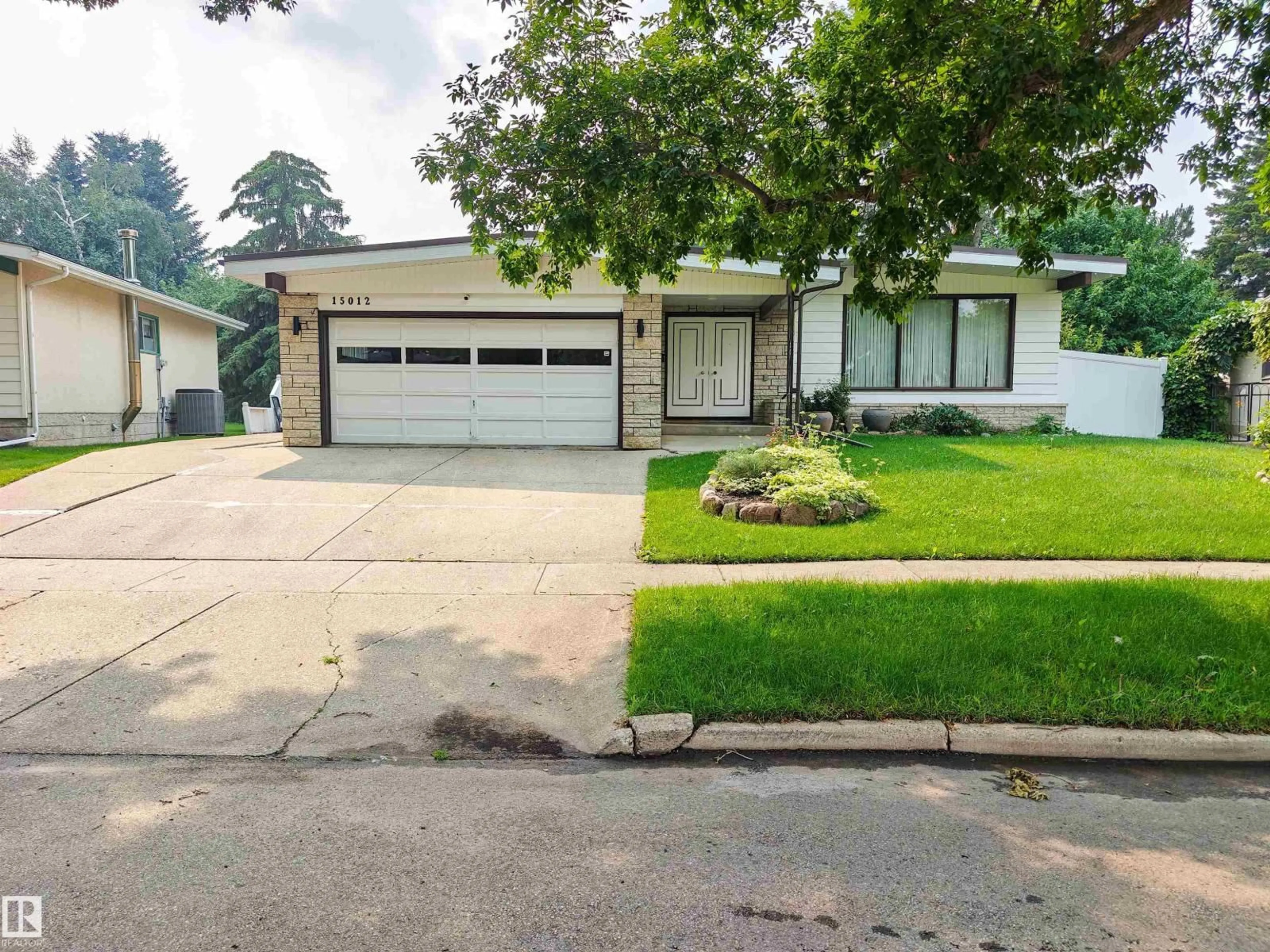 Home with vinyl exterior material, street for NW - 15012 63 ST, Edmonton Alberta T5A2B8