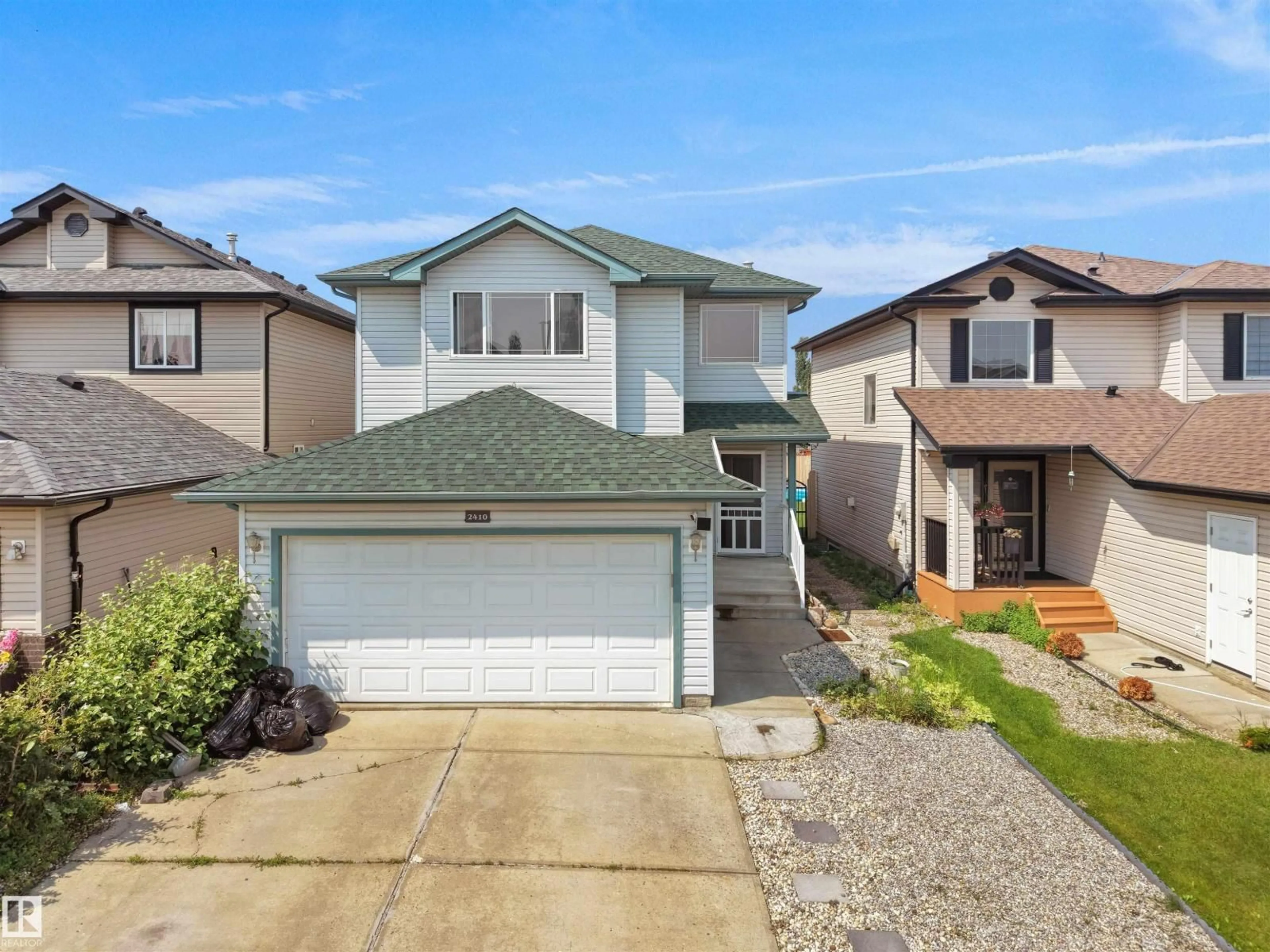 Home with vinyl exterior material, street for NW - 2410 32B ST, Edmonton Alberta T6T1Y6