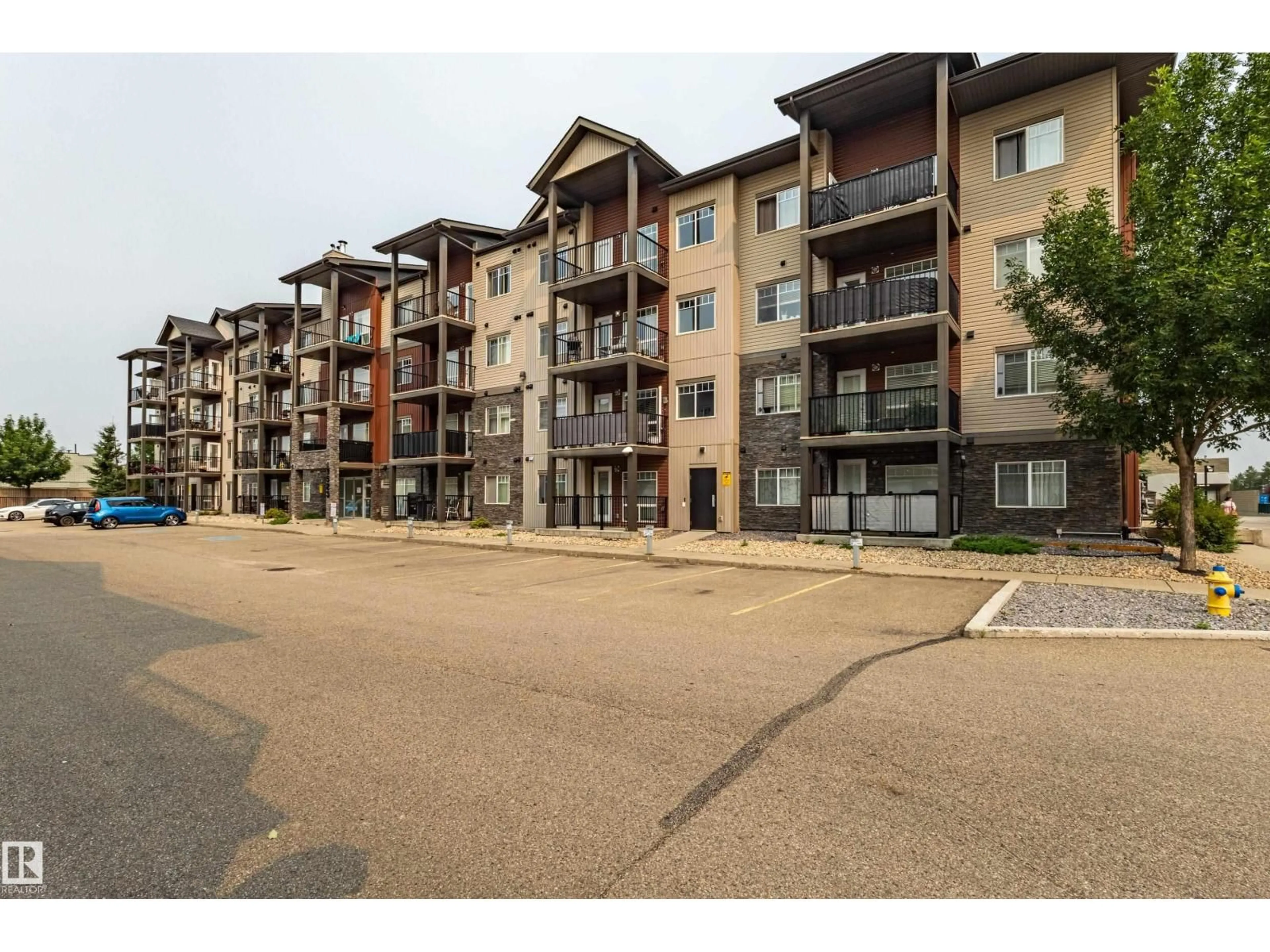 A pic from outside/outdoor area/front of a property/back of a property/a pic from drone, street for 407 - 9523 160 AV, Edmonton Alberta T5Z0N1