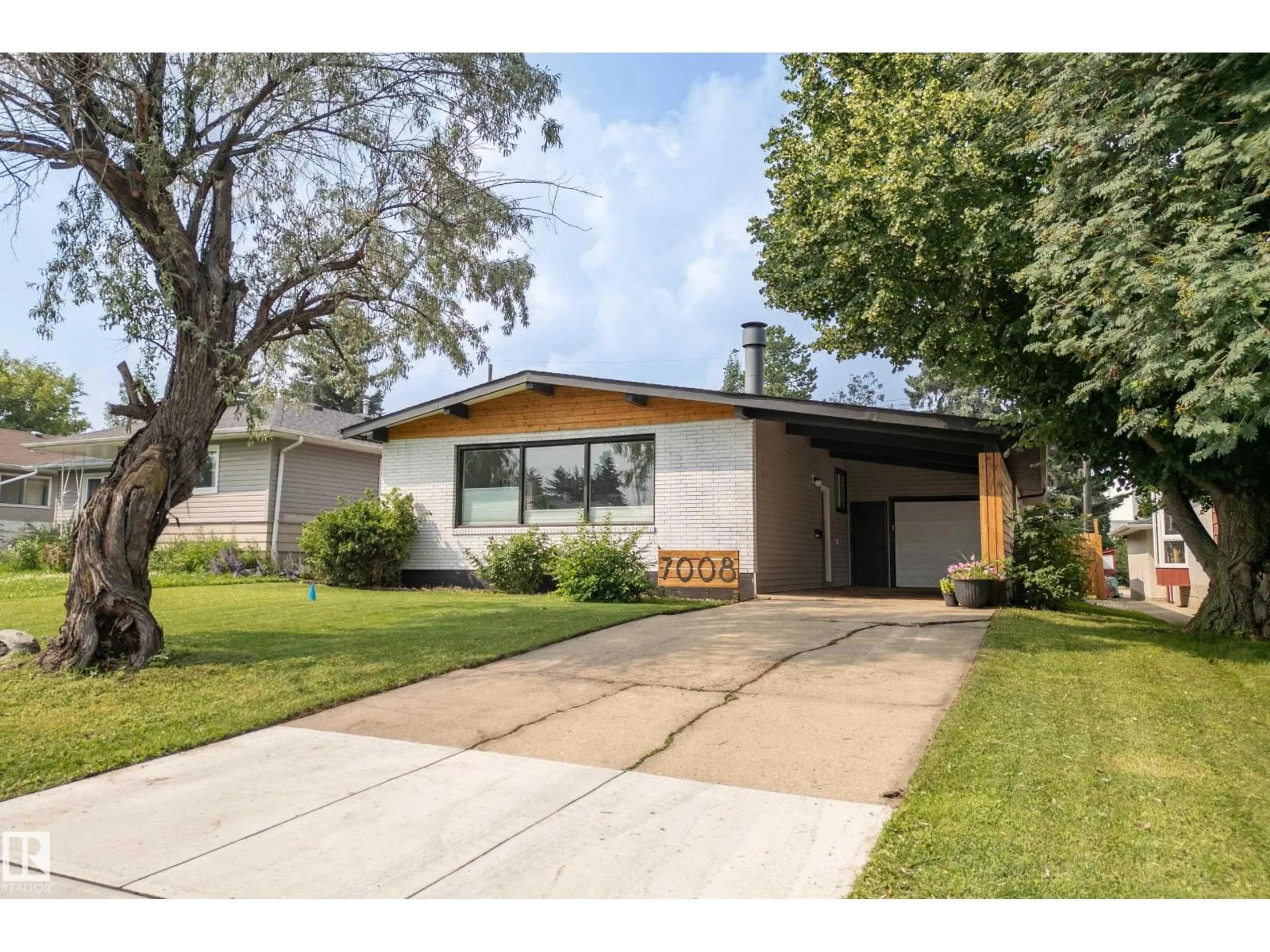 Home with vinyl exterior material, street for 7008 91 AV, Edmonton Alberta T6B0R6