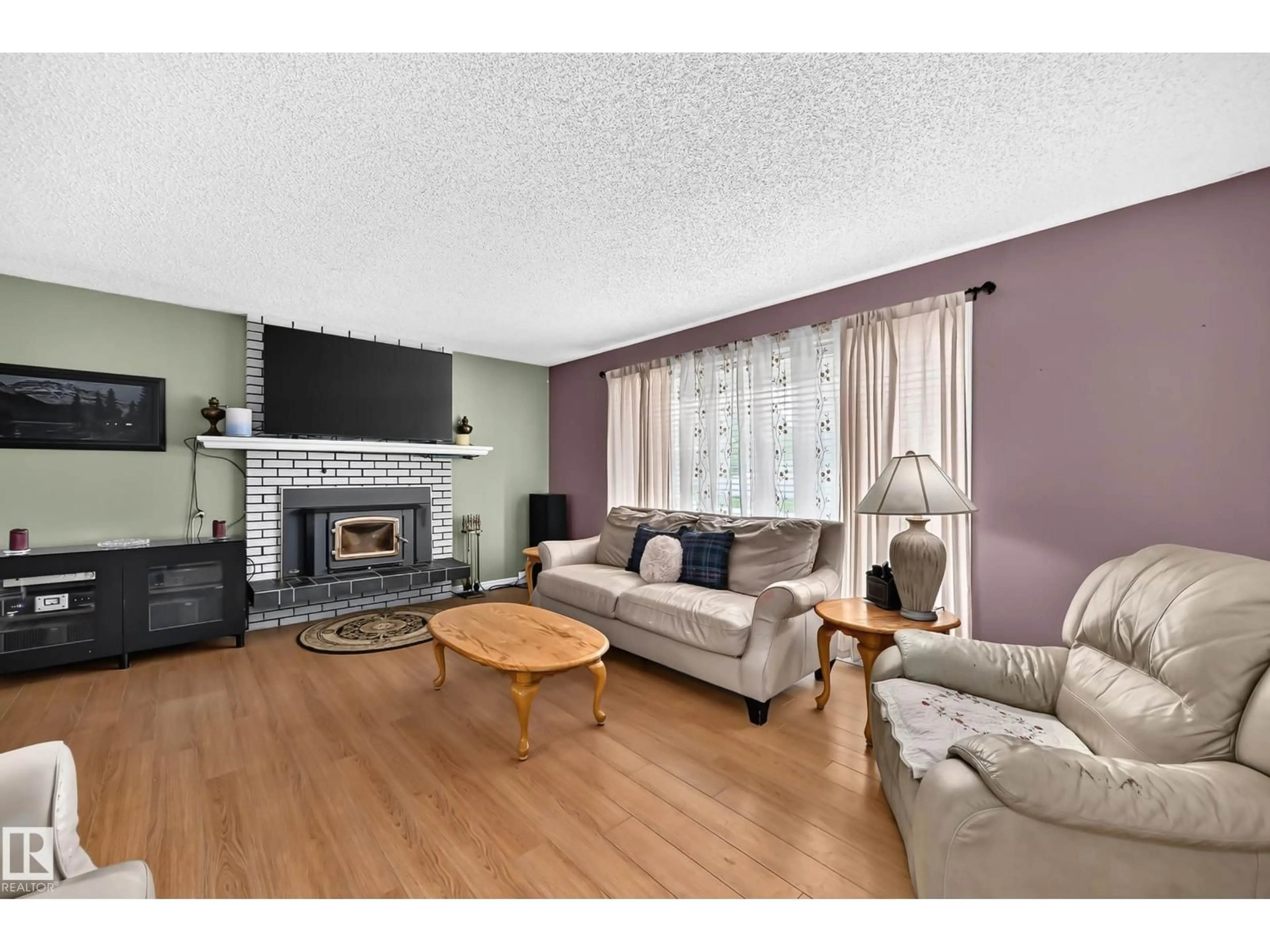 Living room with furniture, wood/laminate floor for 9205 84 ST, Fort Saskatchewan Alberta T8L3N9