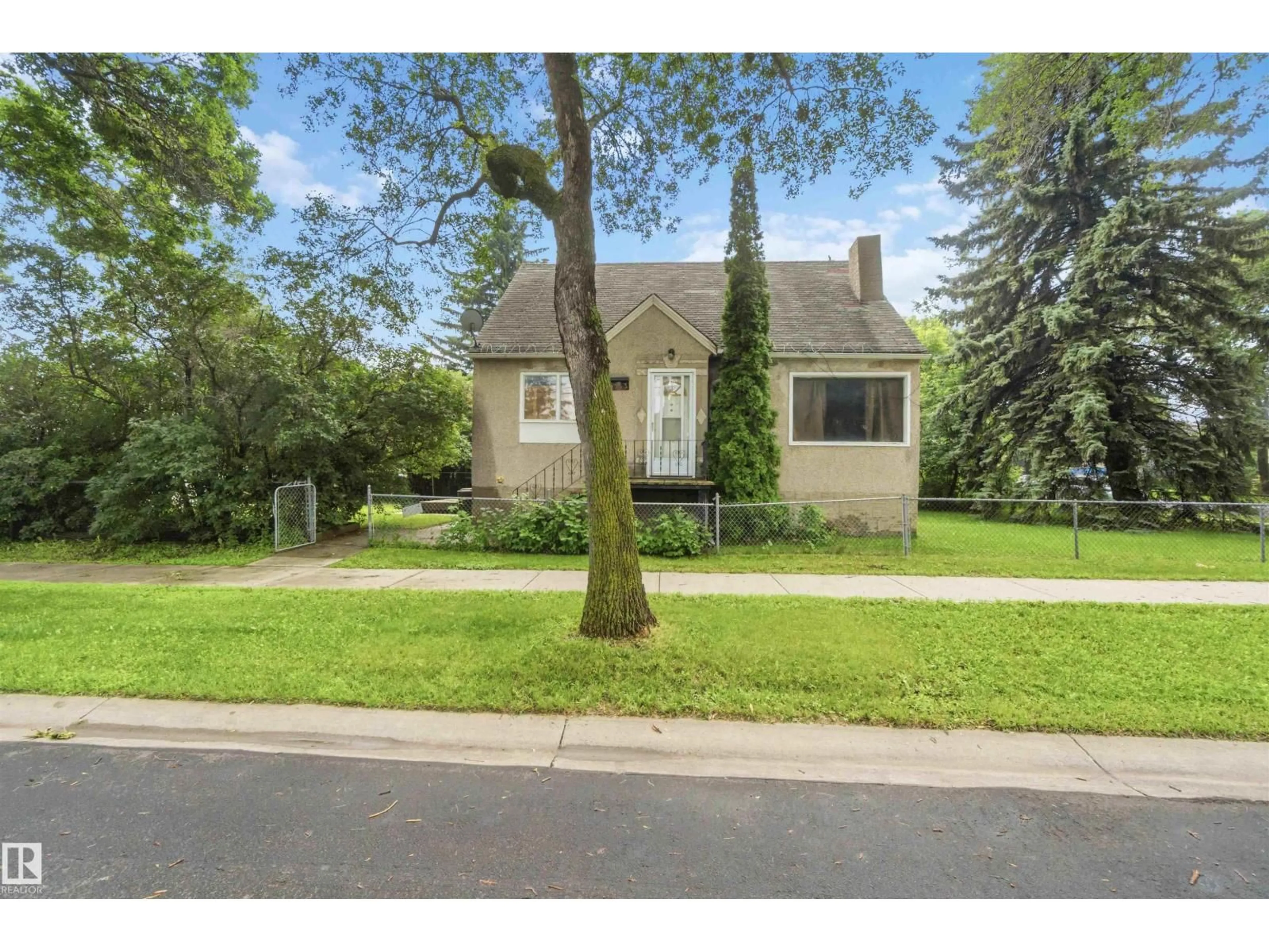 Home with vinyl exterior material, street for 12243 104 ST, Edmonton Alberta T5G2L7