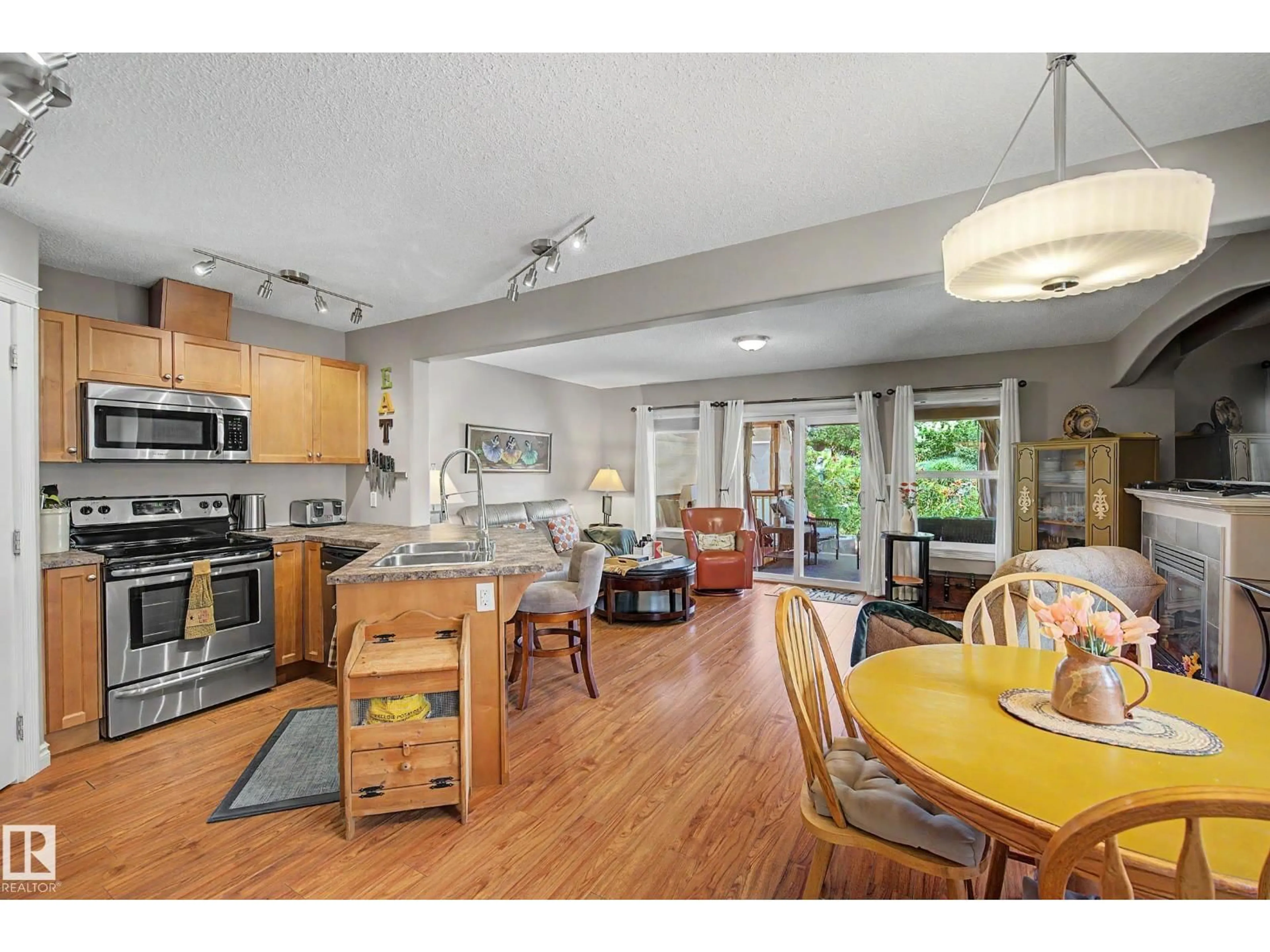 Open concept kitchen, wood/laminate floor for 15144 33 ST, Edmonton Alberta T5Y0J7