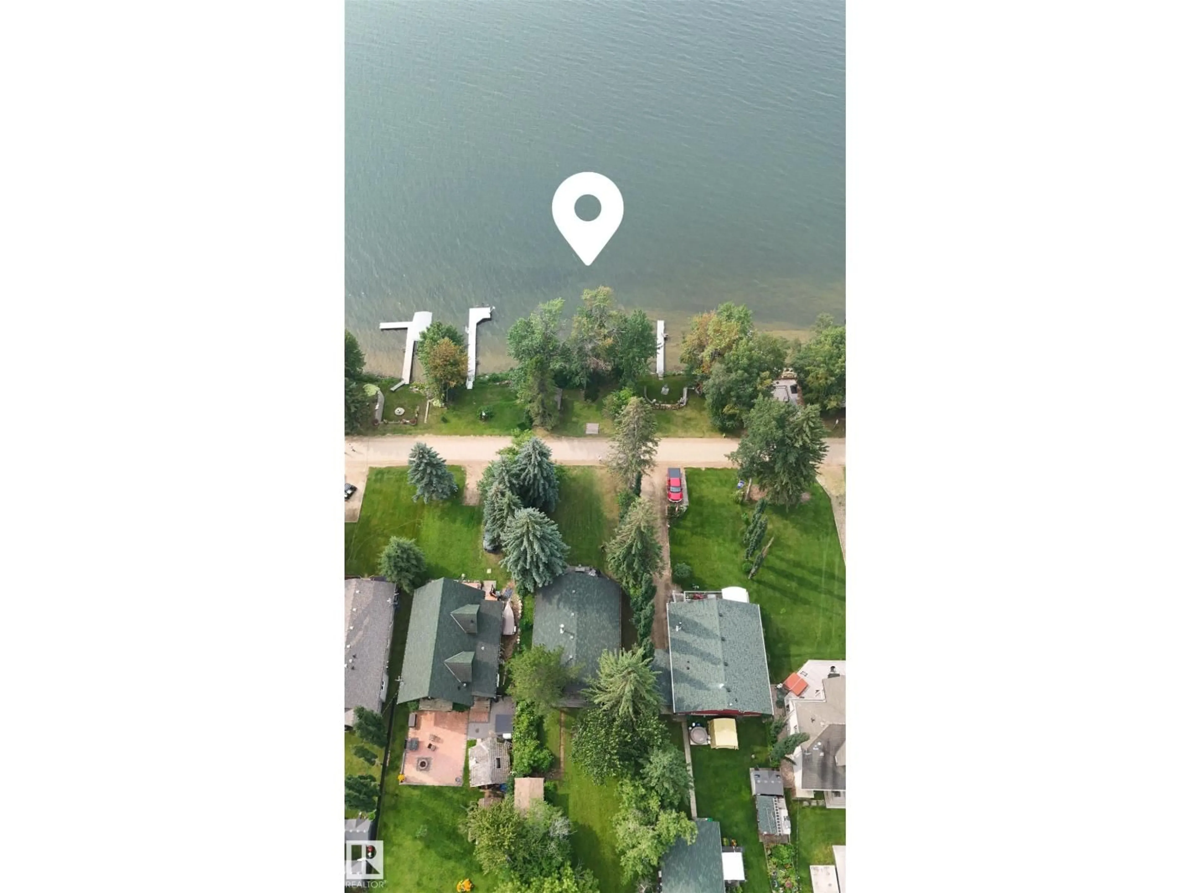 A pic from outside/outdoor area/front of a property/back of a property/a pic from drone, water/lake/river/ocean view for 39 SUNDANCE BE, Rural Leduc County Alberta T0C2P0