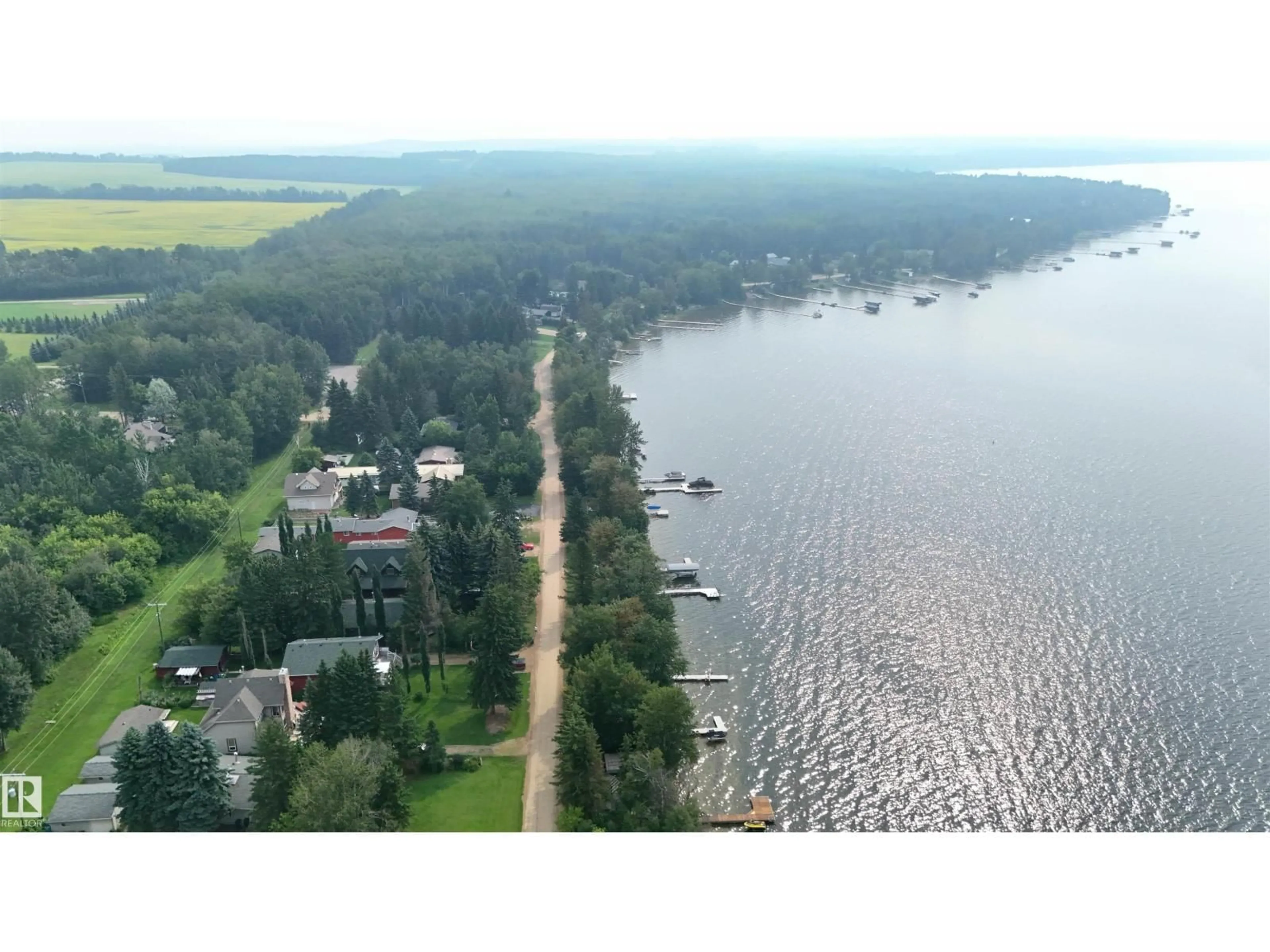 A pic from outside/outdoor area/front of a property/back of a property/a pic from drone, water/lake/river/ocean view for 39 SUNDANCE BE, Rural Leduc County Alberta T0C2P0