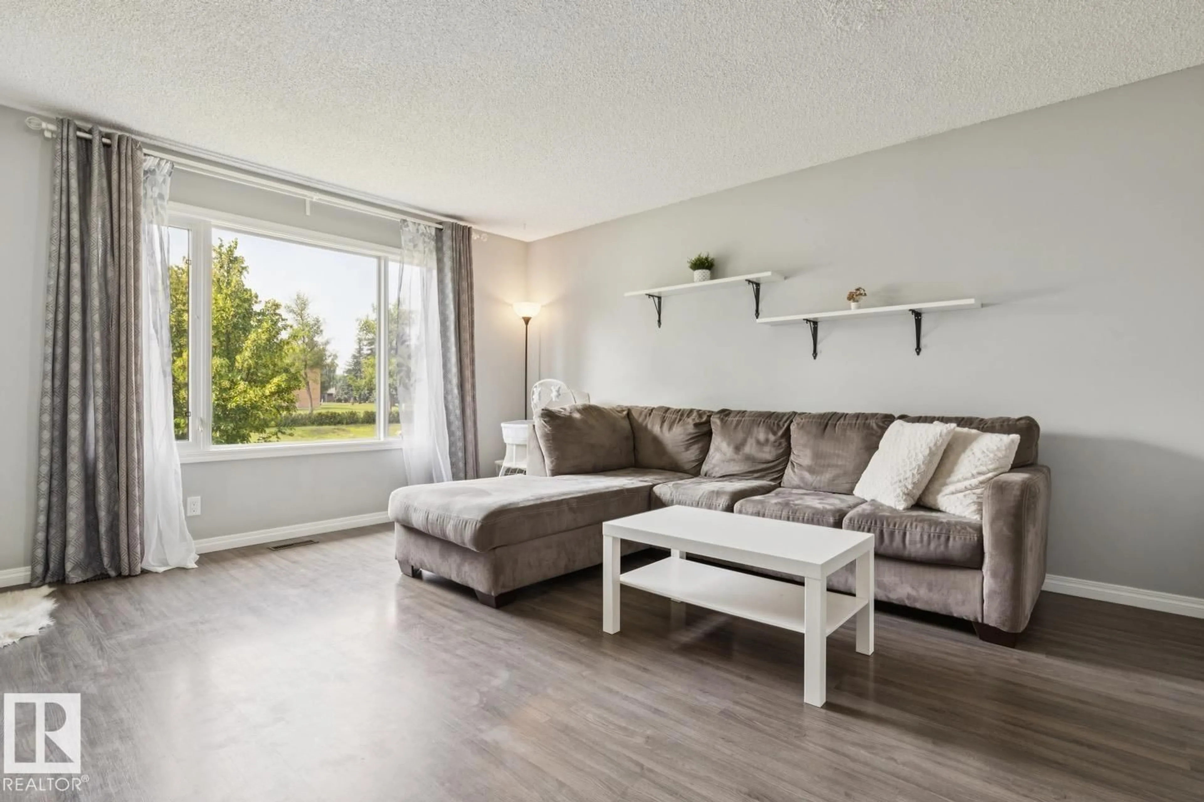Living room with furniture, wood/laminate floor for 11421 22 AV, Edmonton Alberta T6J4V8