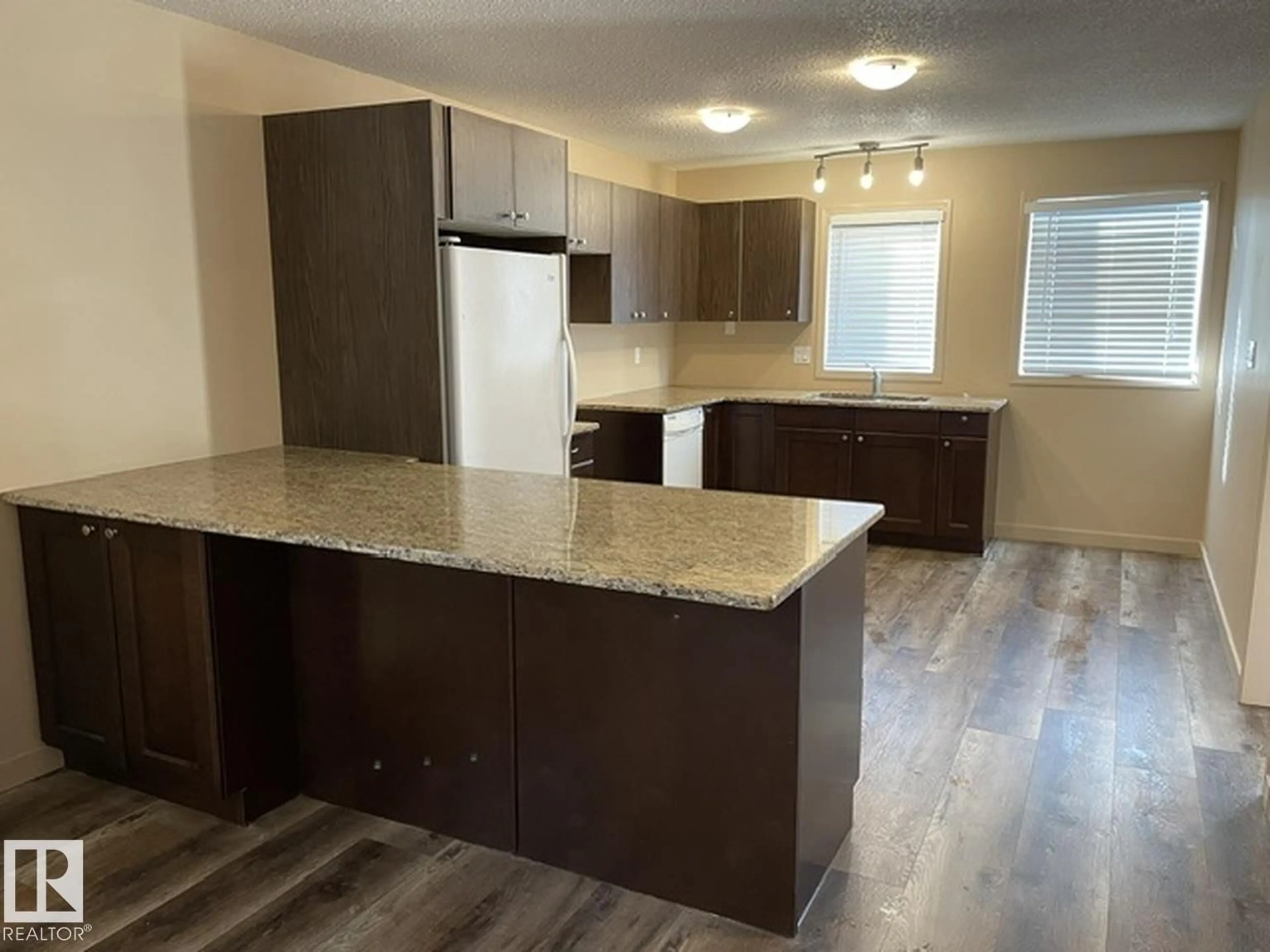 Open concept kitchen, wood/laminate floor for NW - 7712 110 ST, Edmonton Alberta T6G1G1