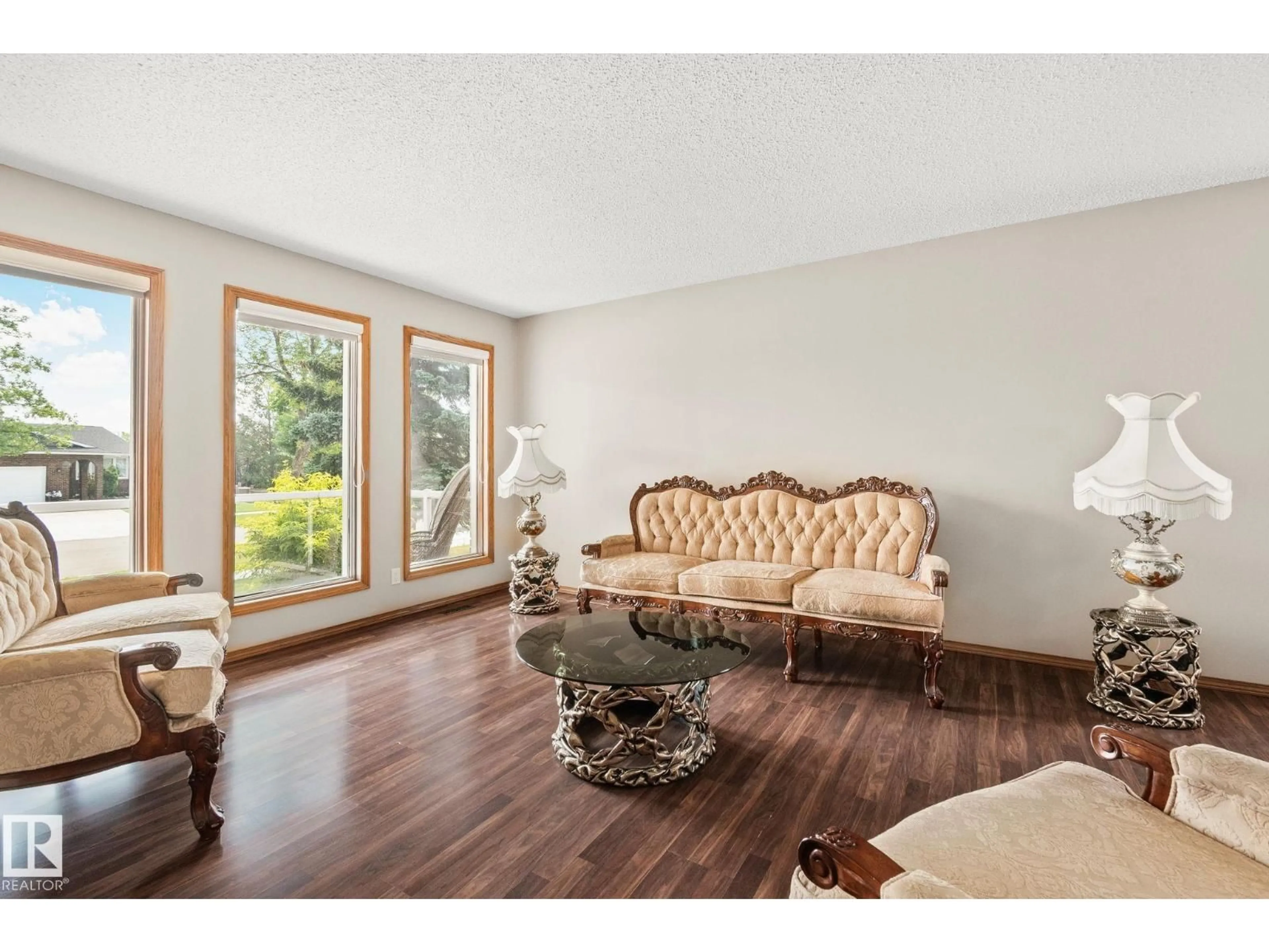 Living room with furniture, wood/laminate floor for NW - 16012 109 ST, Edmonton Alberta T5X4R9