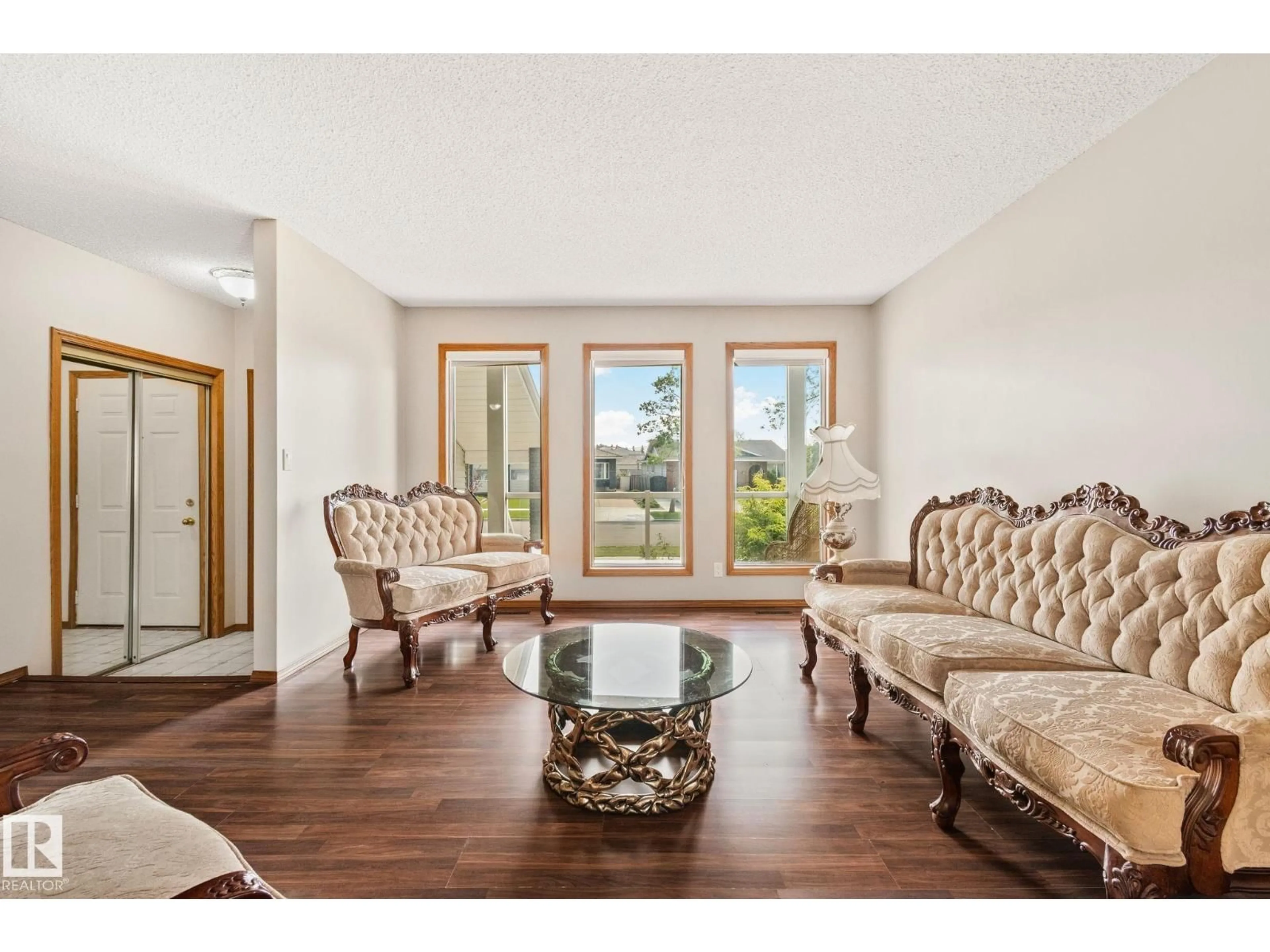 Living room with furniture, wood/laminate floor for NW - 16012 109 ST, Edmonton Alberta T5X4R9