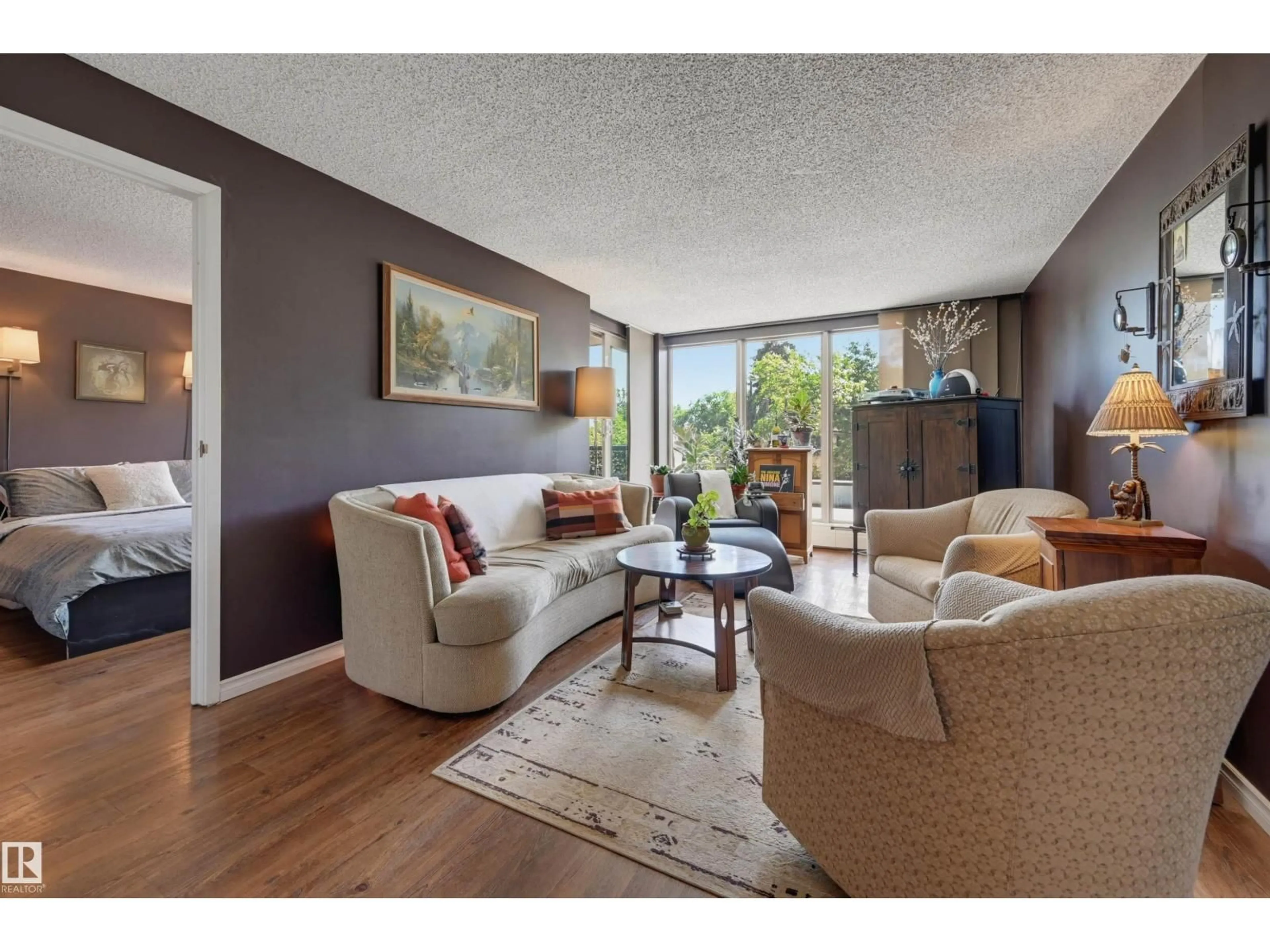 Living room with furniture, wood/laminate floor for 210 - 10149 SASKATCHEWAN DR, Edmonton Alberta T6E6B6