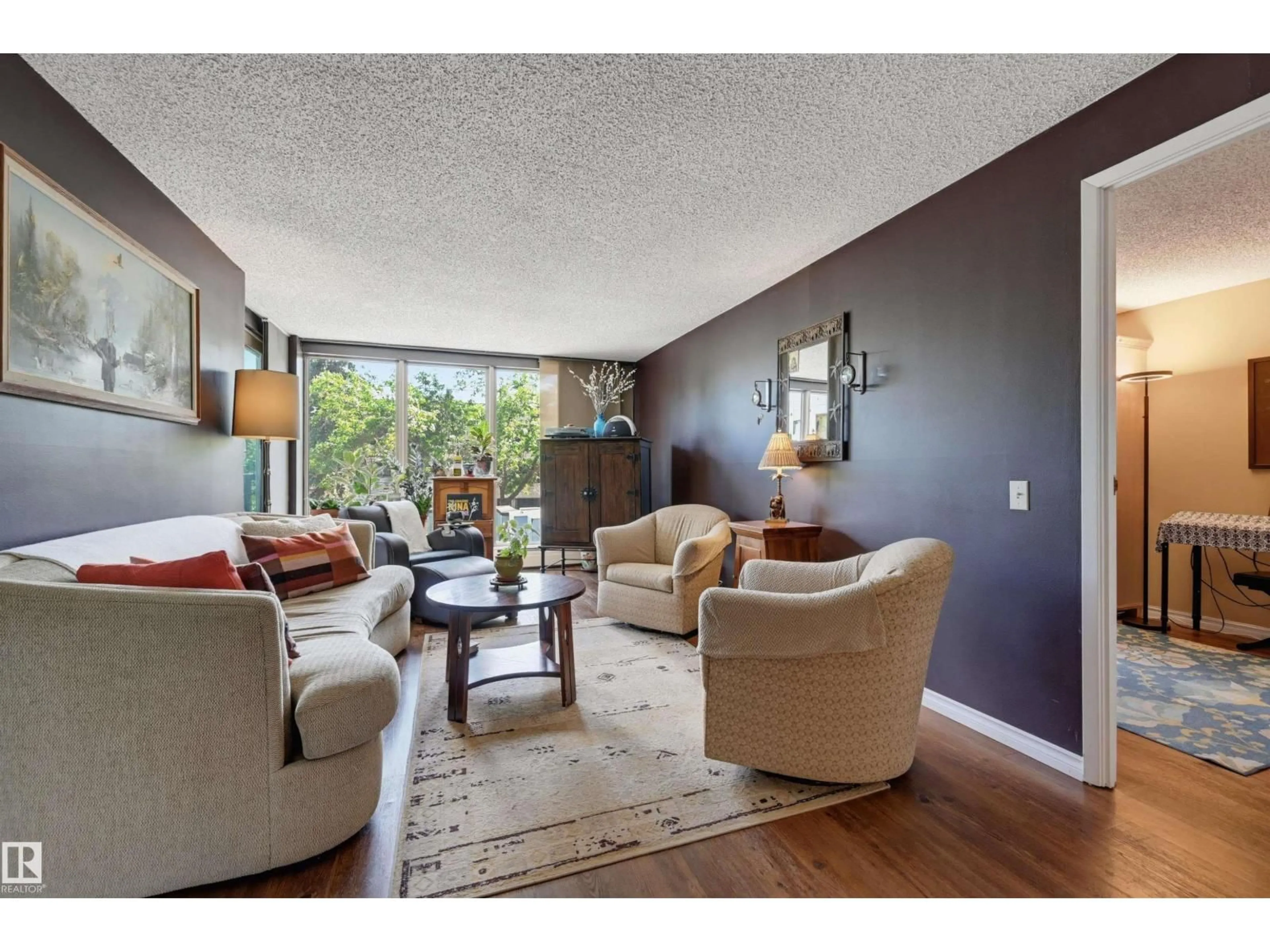 Living room with furniture, wood/laminate floor for 210 - 10149 SASKATCHEWAN DR, Edmonton Alberta T6E6B6