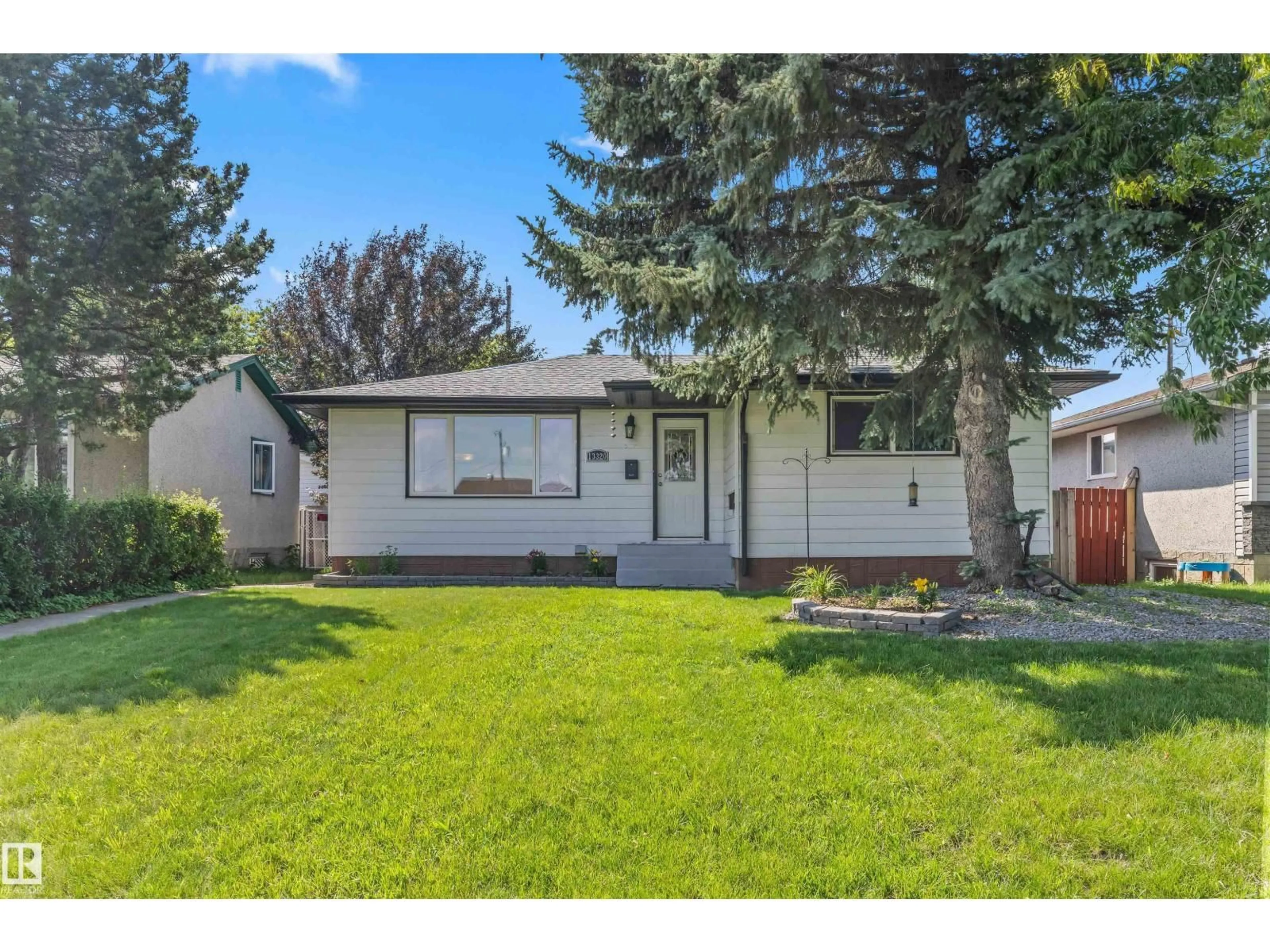 Home with vinyl exterior material, street for 13320 123 ST, Edmonton Alberta T5L0J9