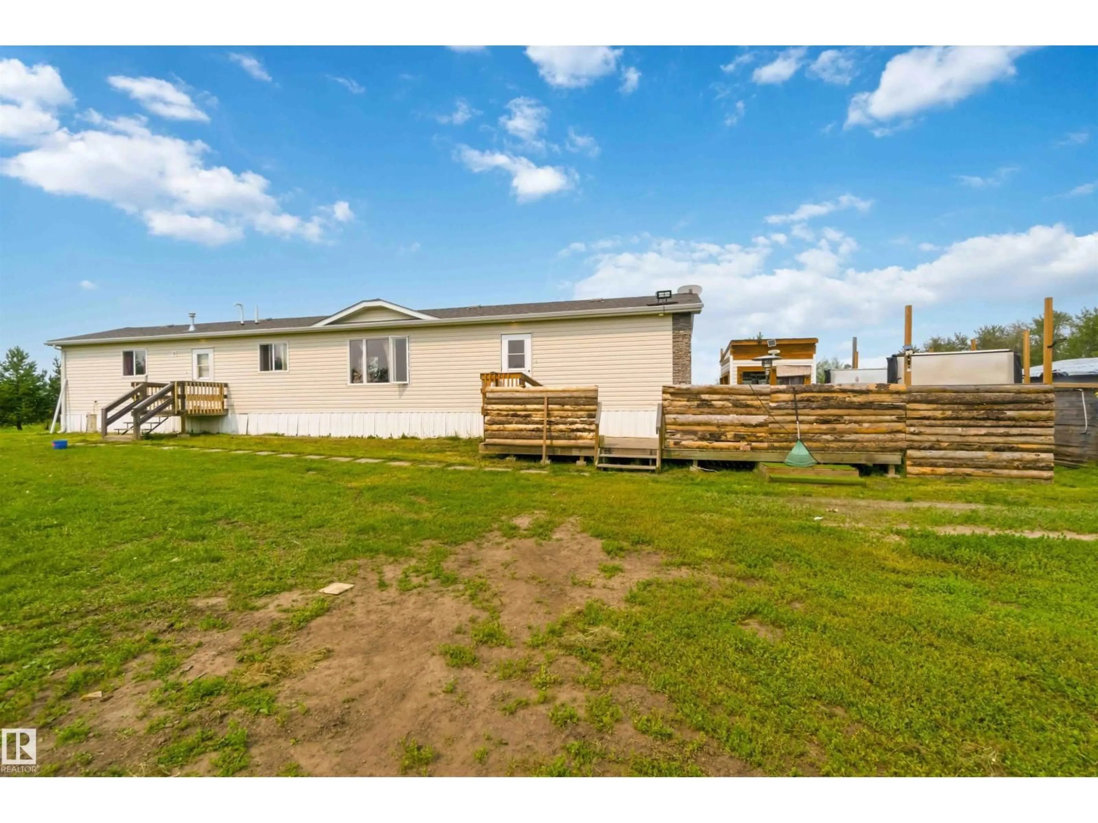 A pic from outside/outdoor area/front of a property/back of a property/a pic from drone, building for 273 - 58502 RNG RD 2, Rural Westlock County Alberta T0G1W0