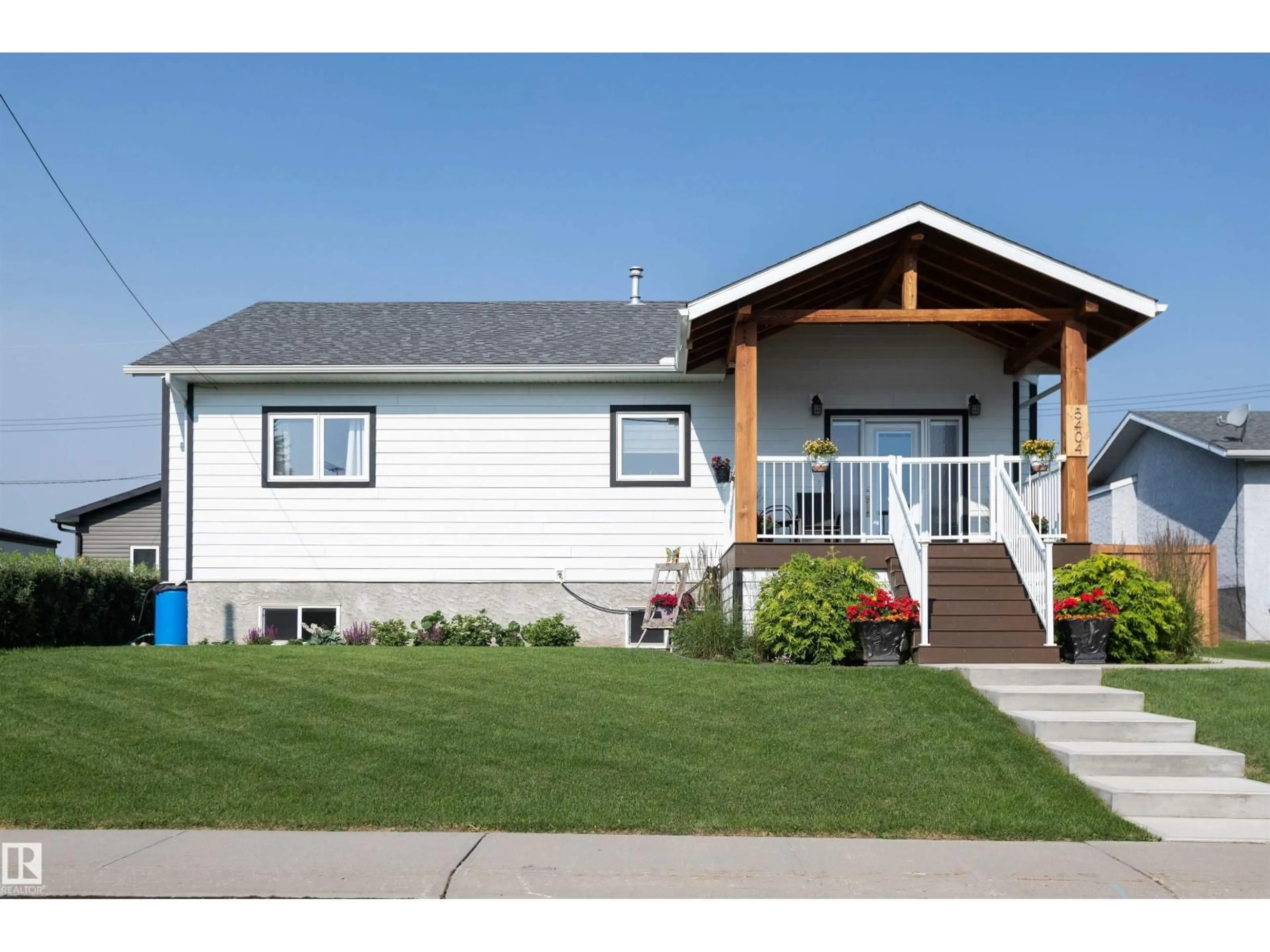 Home with vinyl exterior material, street for 5404 60TH STREET, Barrhead Alberta T7N1C1