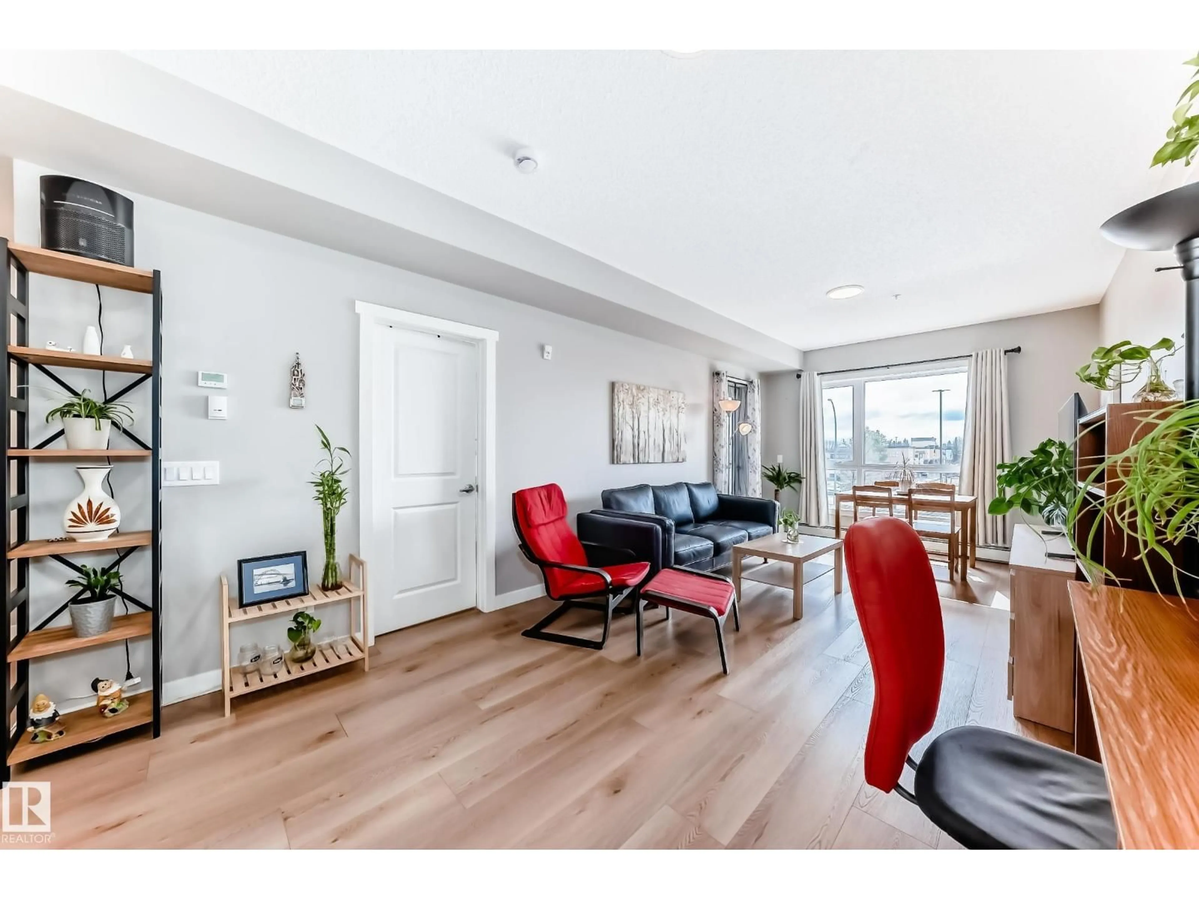 Living room with furniture, wood/laminate floor for #221 - 12804 140 AV, Edmonton Alberta T6V0M3