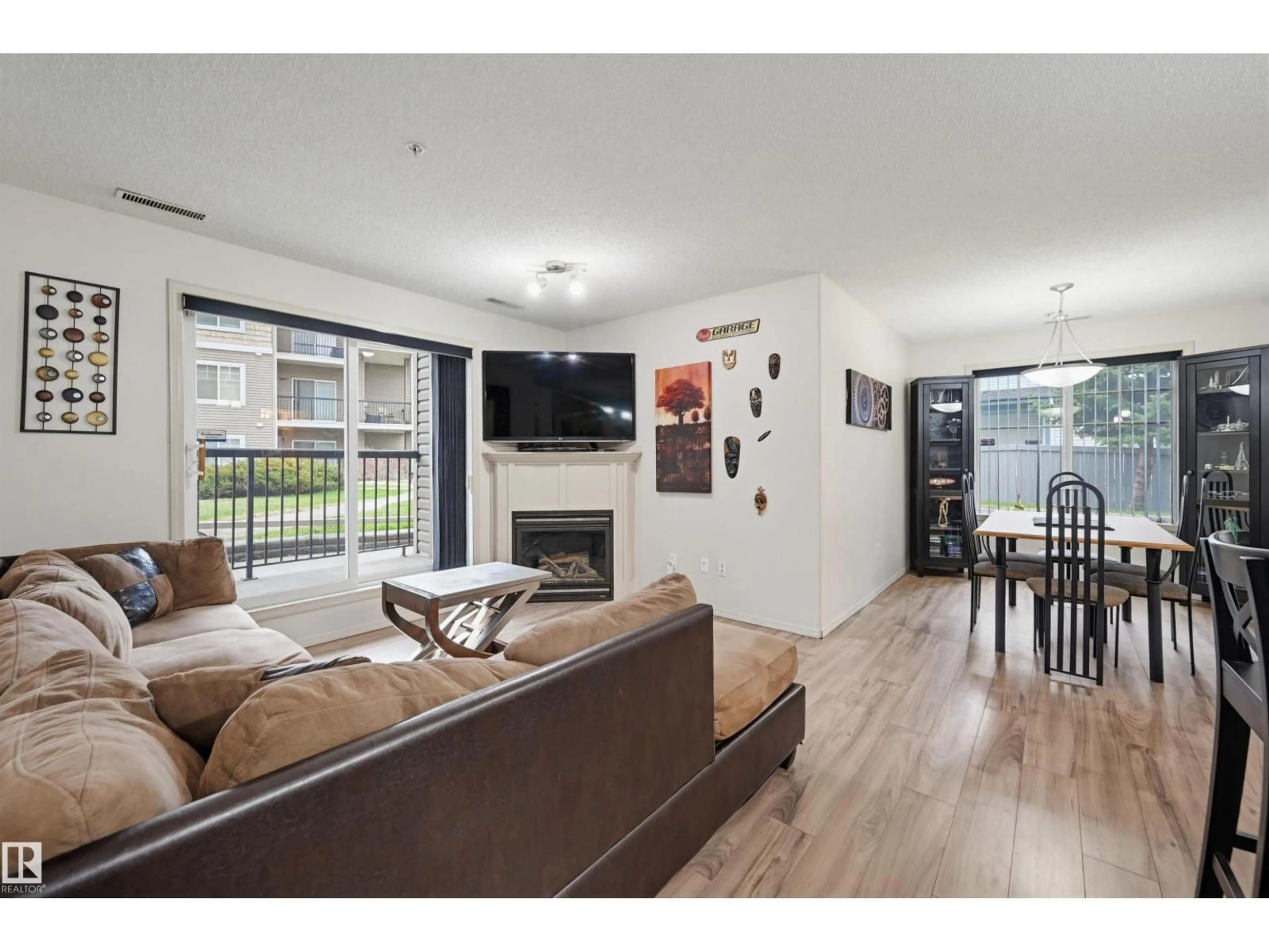 Living room with furniture, wood/laminate floor for #121 - 17415 99 AV, Edmonton Alberta T5T0W8