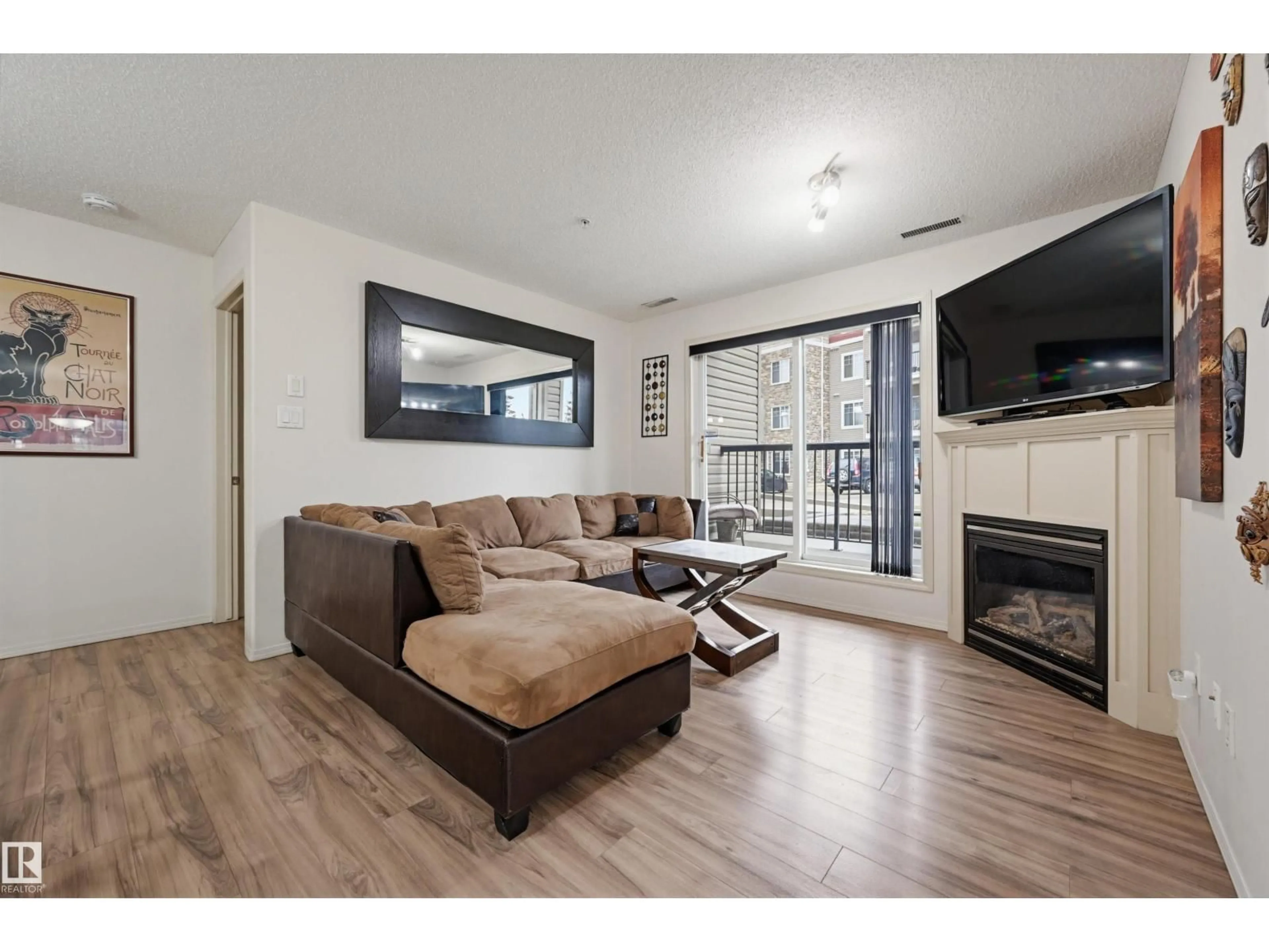 Living room with furniture, wood/laminate floor for #121 - 17415 99 AV, Edmonton Alberta T5T0W8