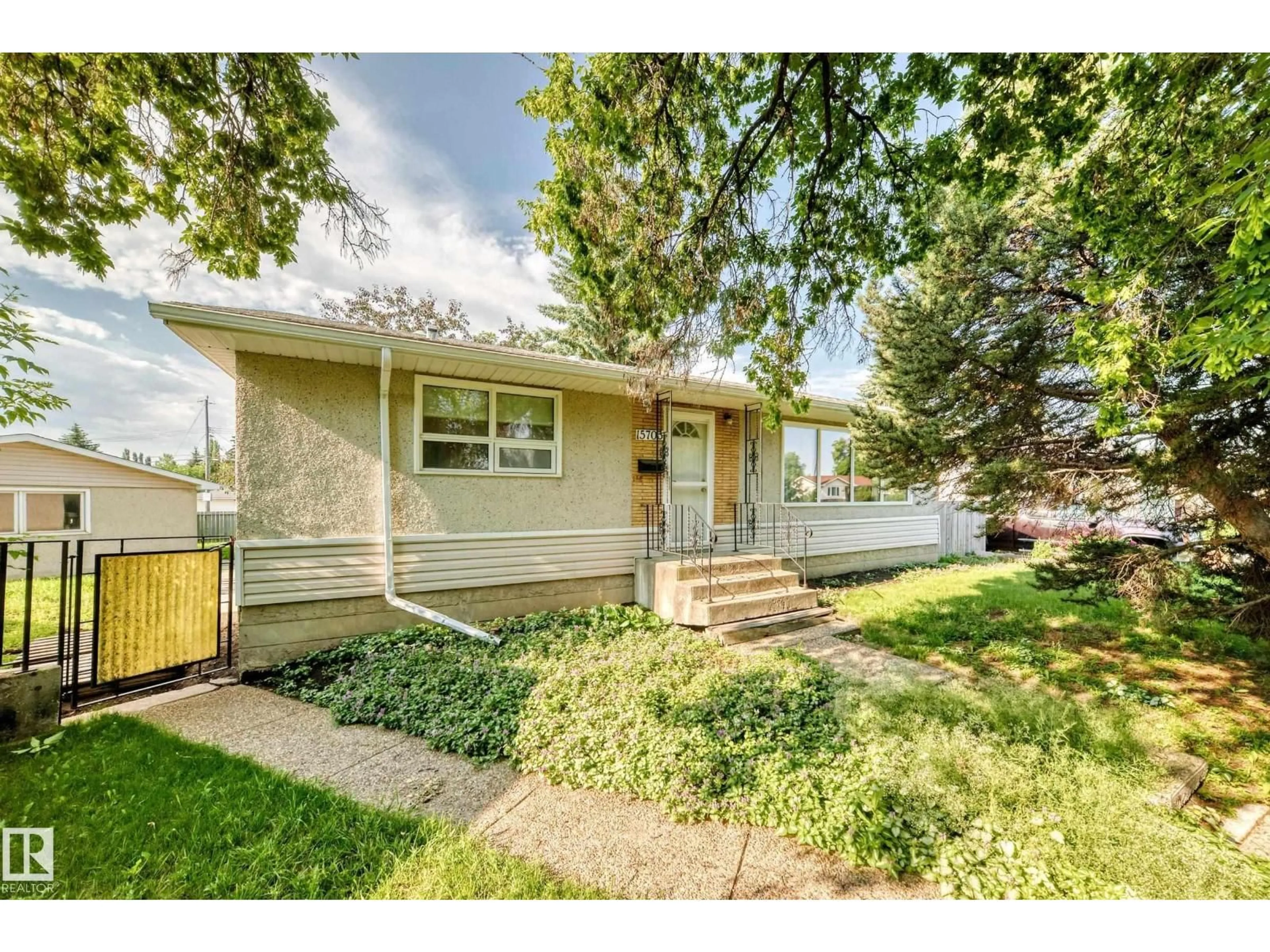 Home with vinyl exterior material, street for NW - 15703 84 AV, Edmonton Alberta T5R3Y2