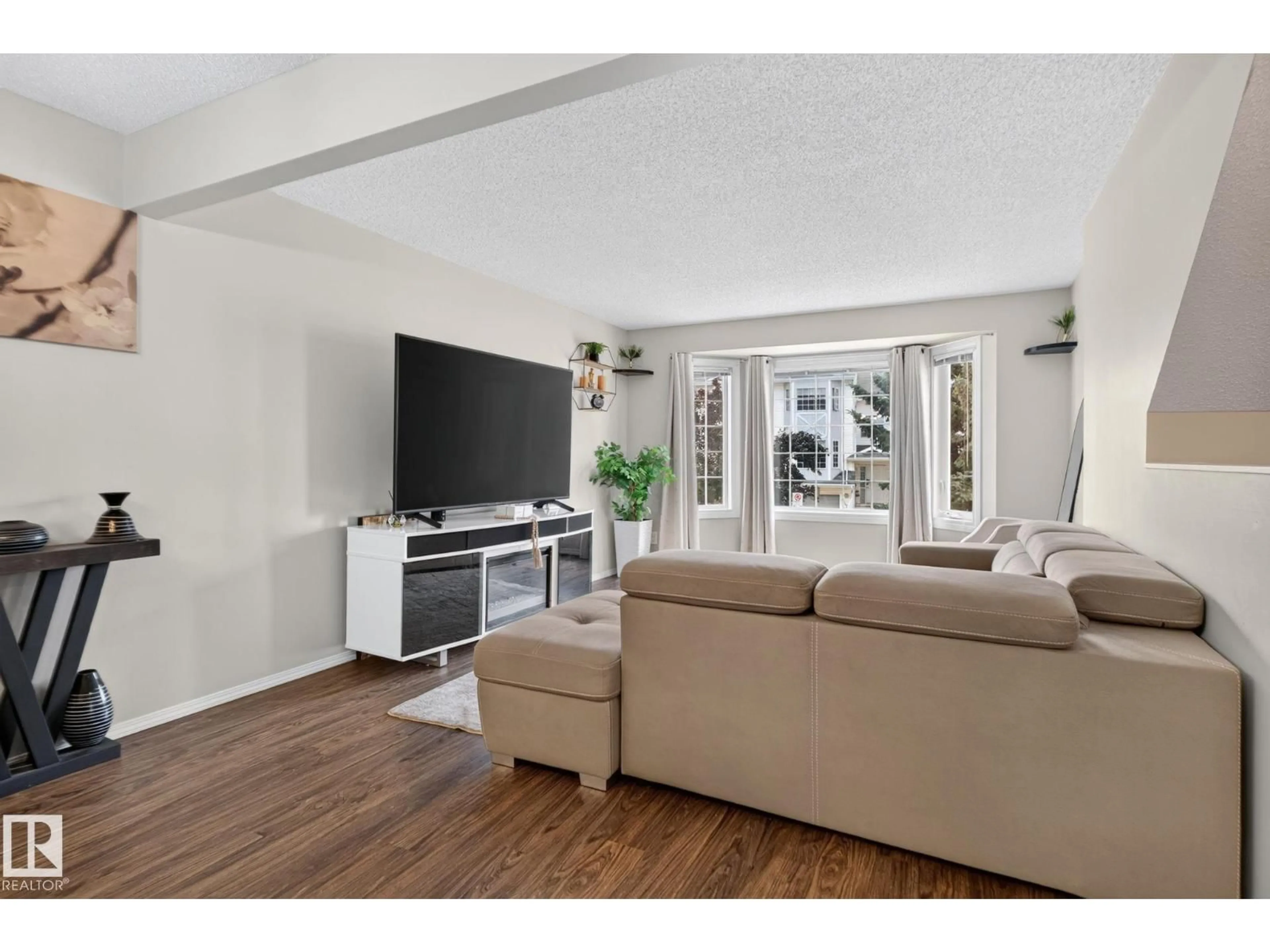 Living room with furniture, wood/laminate floor for 15174 22 ST, Edmonton Alberta T5Y2T2