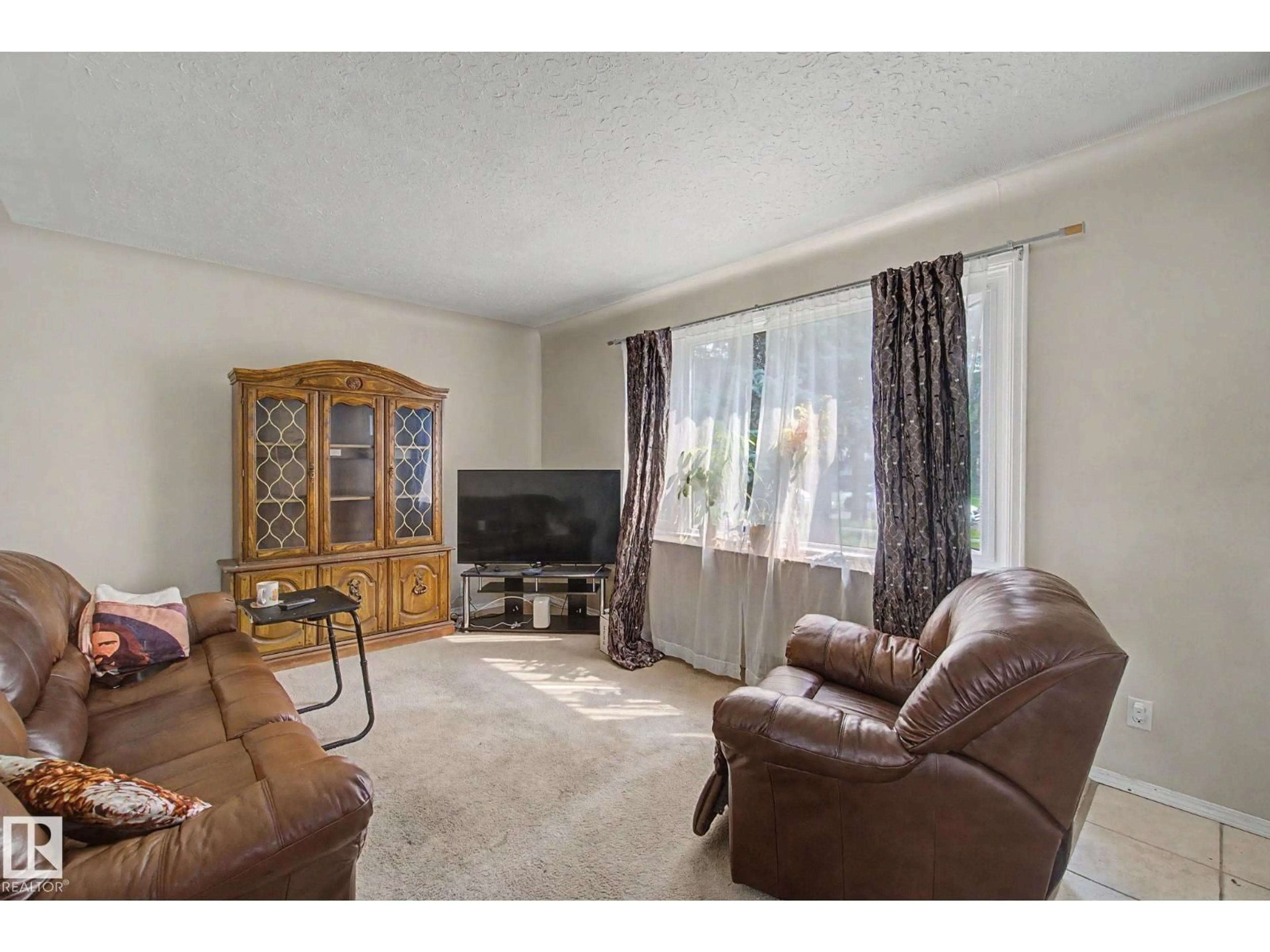 Living room with furniture, unknown for 8710 83 AV, Edmonton Alberta T6C1B3