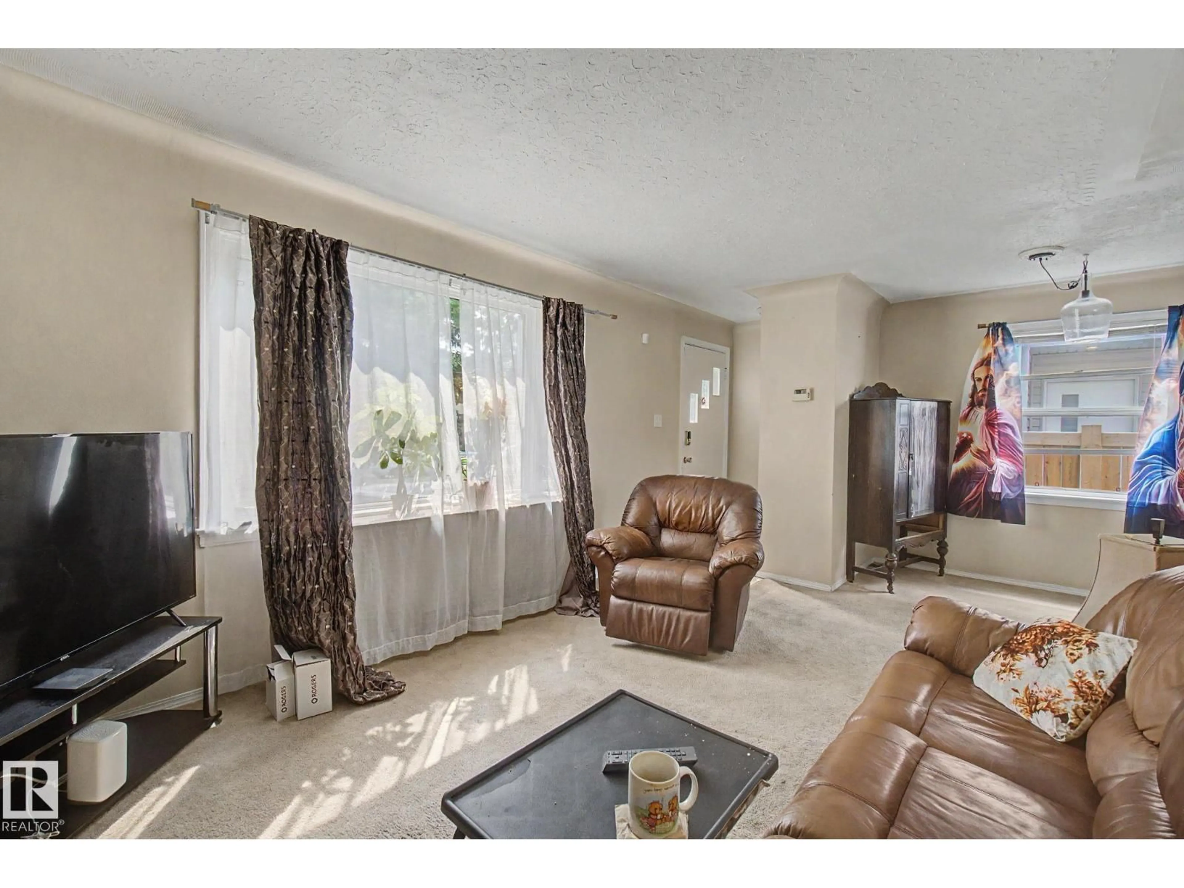 Living room with furniture, unknown for 8710 83 AV, Edmonton Alberta T6C1B3