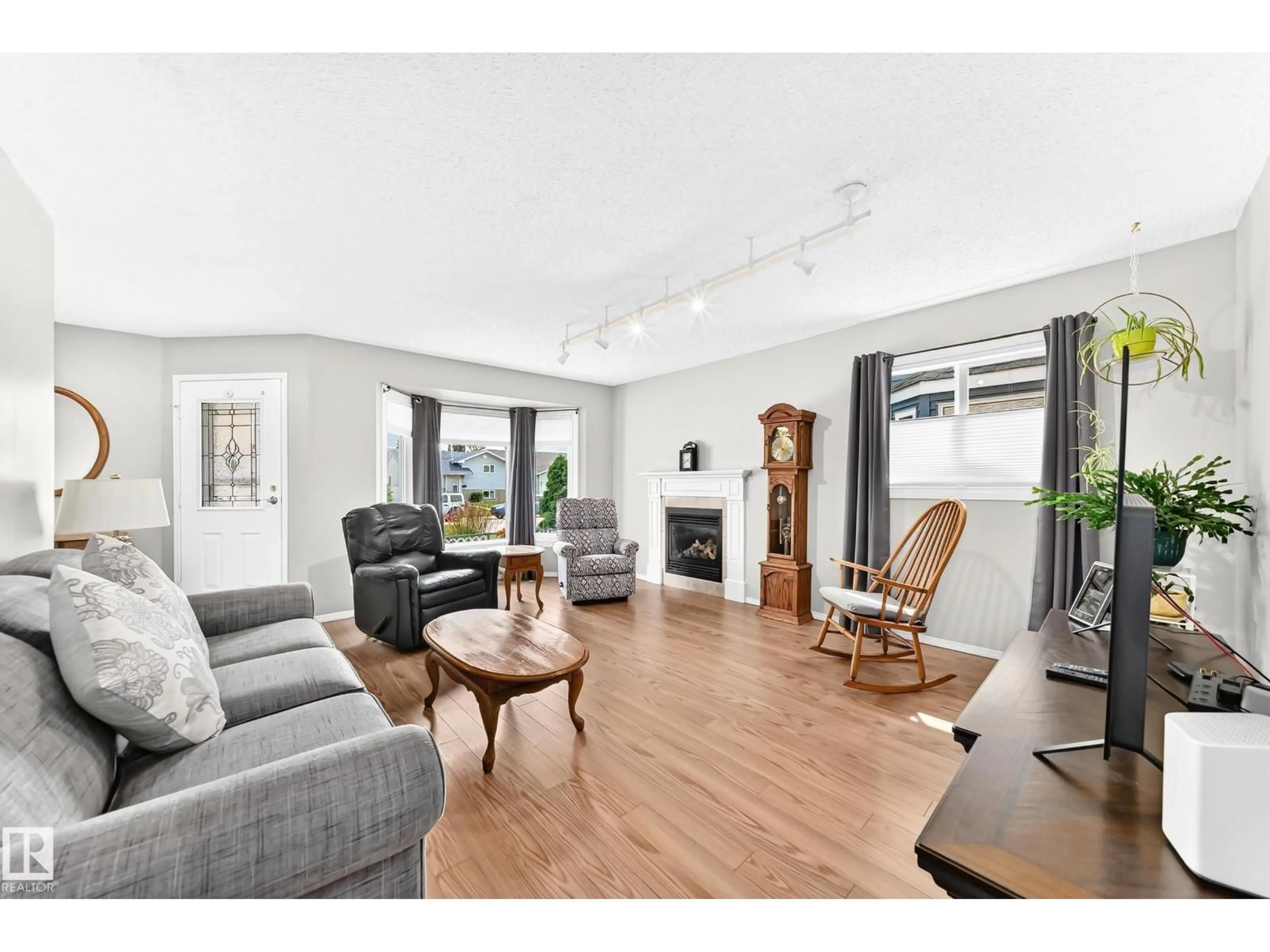 Living room with furniture, wood/laminate floor for NW - 7028 190 ST, Edmonton Alberta T5T5E5