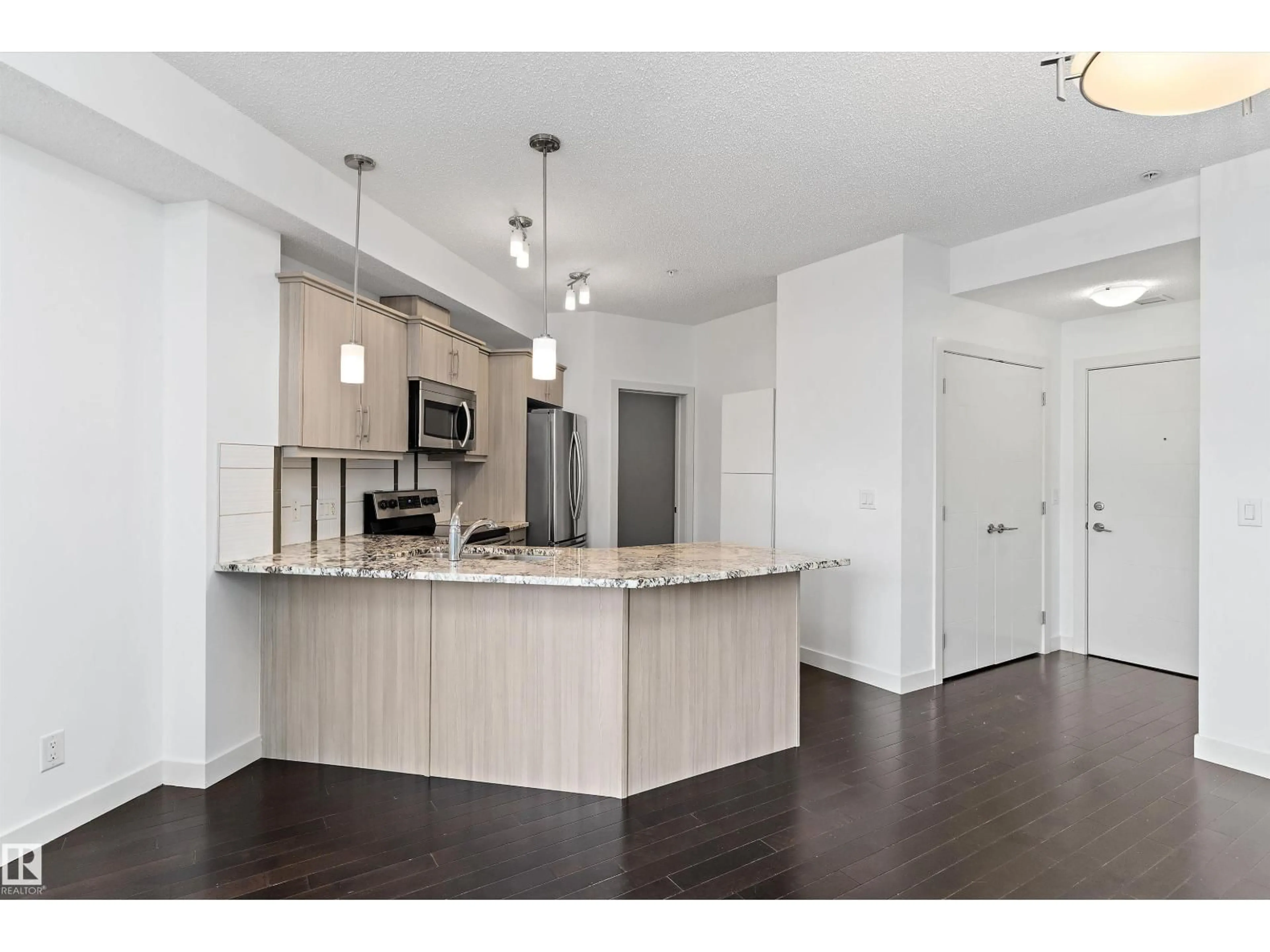 Open concept kitchen, wood/laminate floor for #109 - 10523 123 ST, Edmonton Alberta T5N1N9