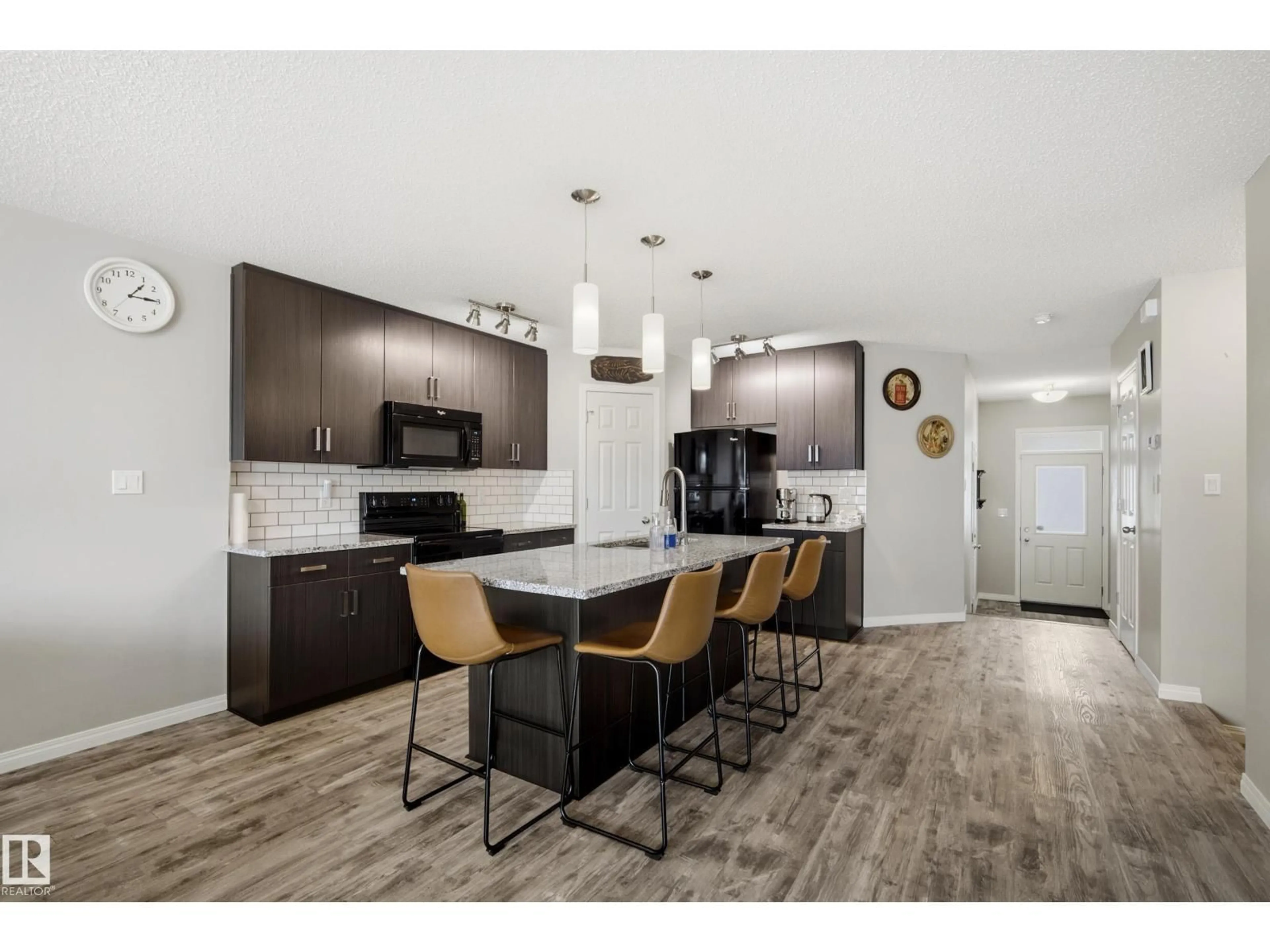 Open concept kitchen, wood/laminate floor for 3805 POWELL WD, Edmonton Alberta T6W2W9