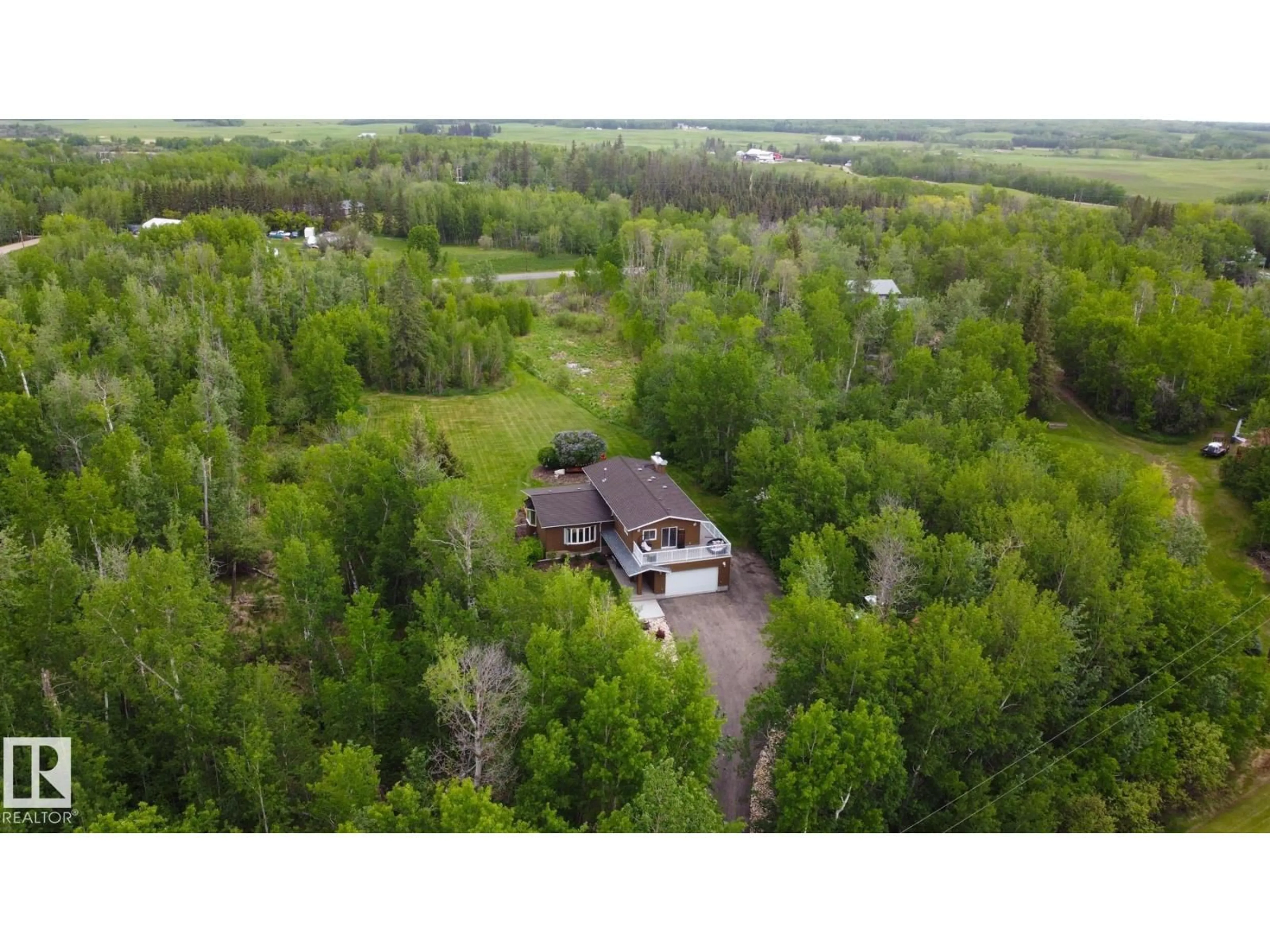 A pic from outside/outdoor area/front of a property/back of a property/a pic from drone, forest/trees view for 100 22549 TWP RD, Rural Leduc County Alberta T8C1H1