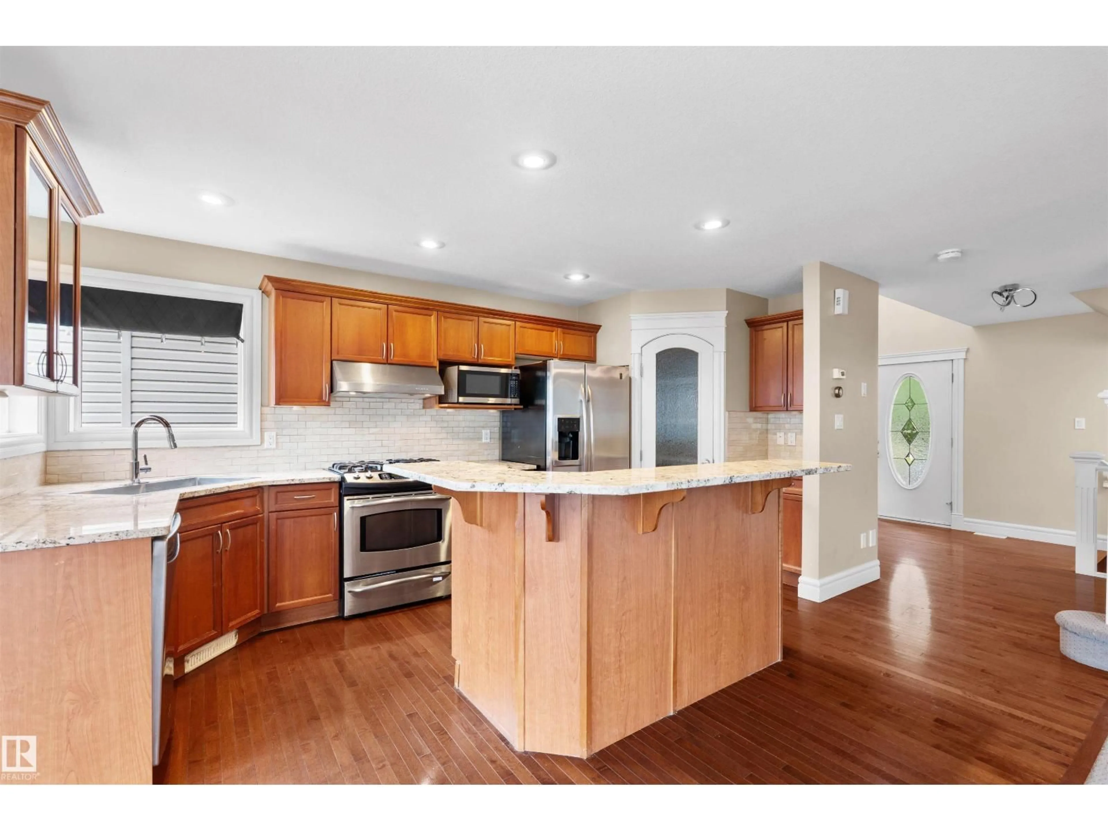 Open concept kitchen, wood/laminate floor for 1338 RUTHERFORD RD, Edmonton Alberta T6W1P3