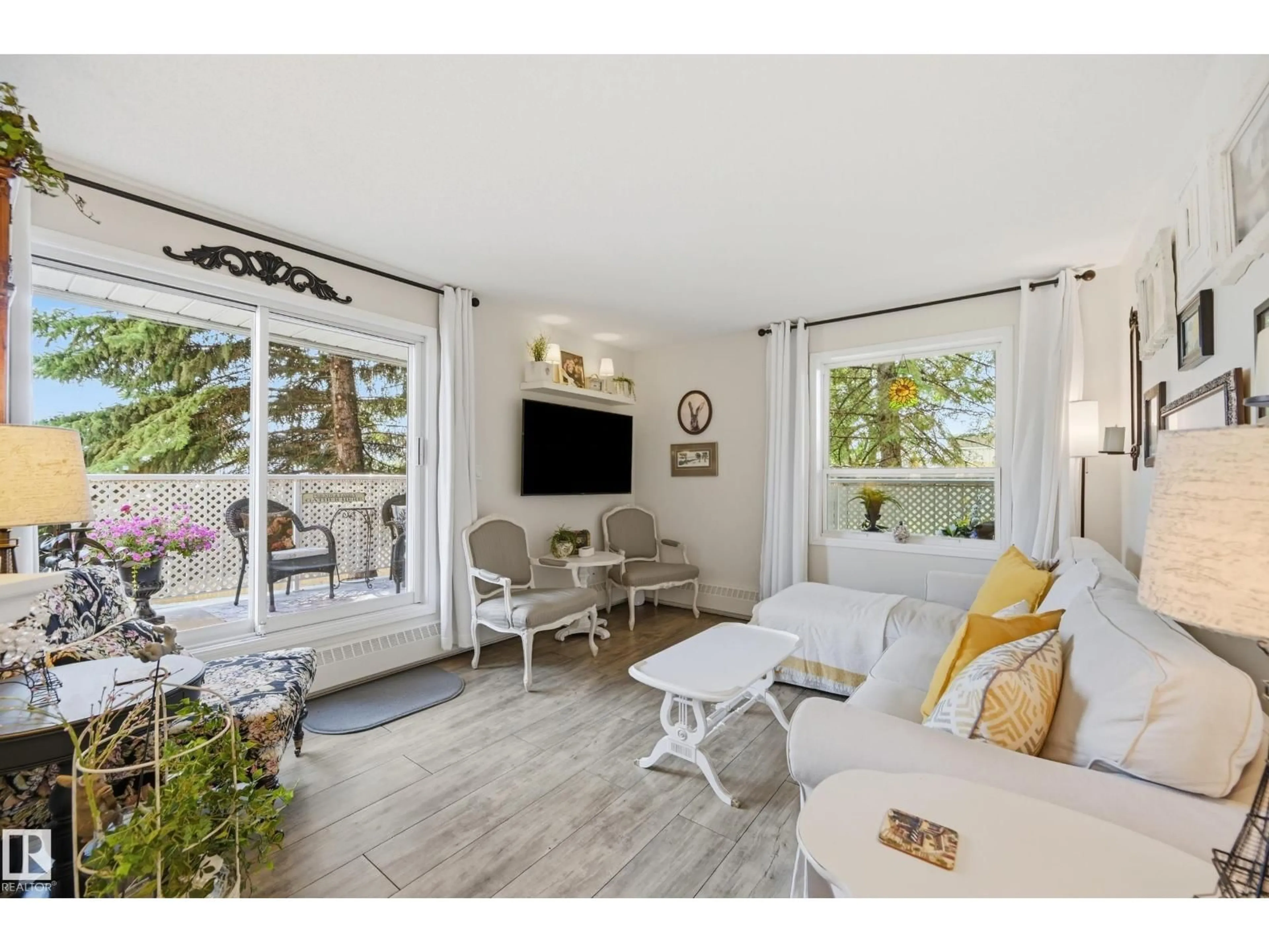 Living room with furniture, wood/laminate floor for 208 - 9760 176 ST, Edmonton Alberta T5T5Z5