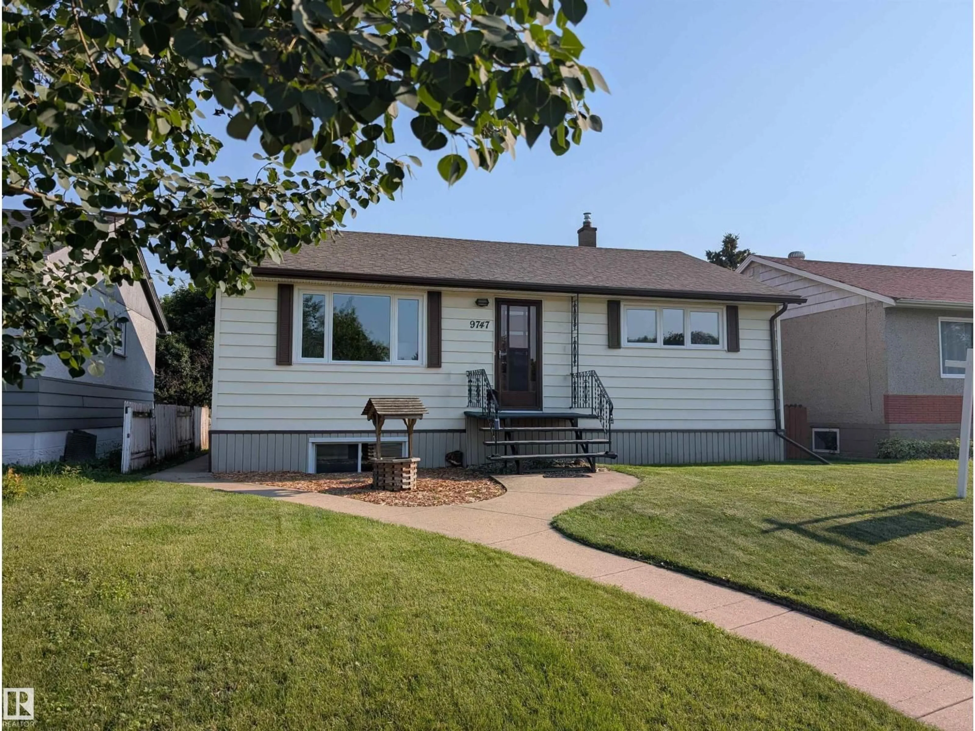 Home with vinyl exterior material, street for 9747 66 AV, Edmonton Alberta T6E0M4
