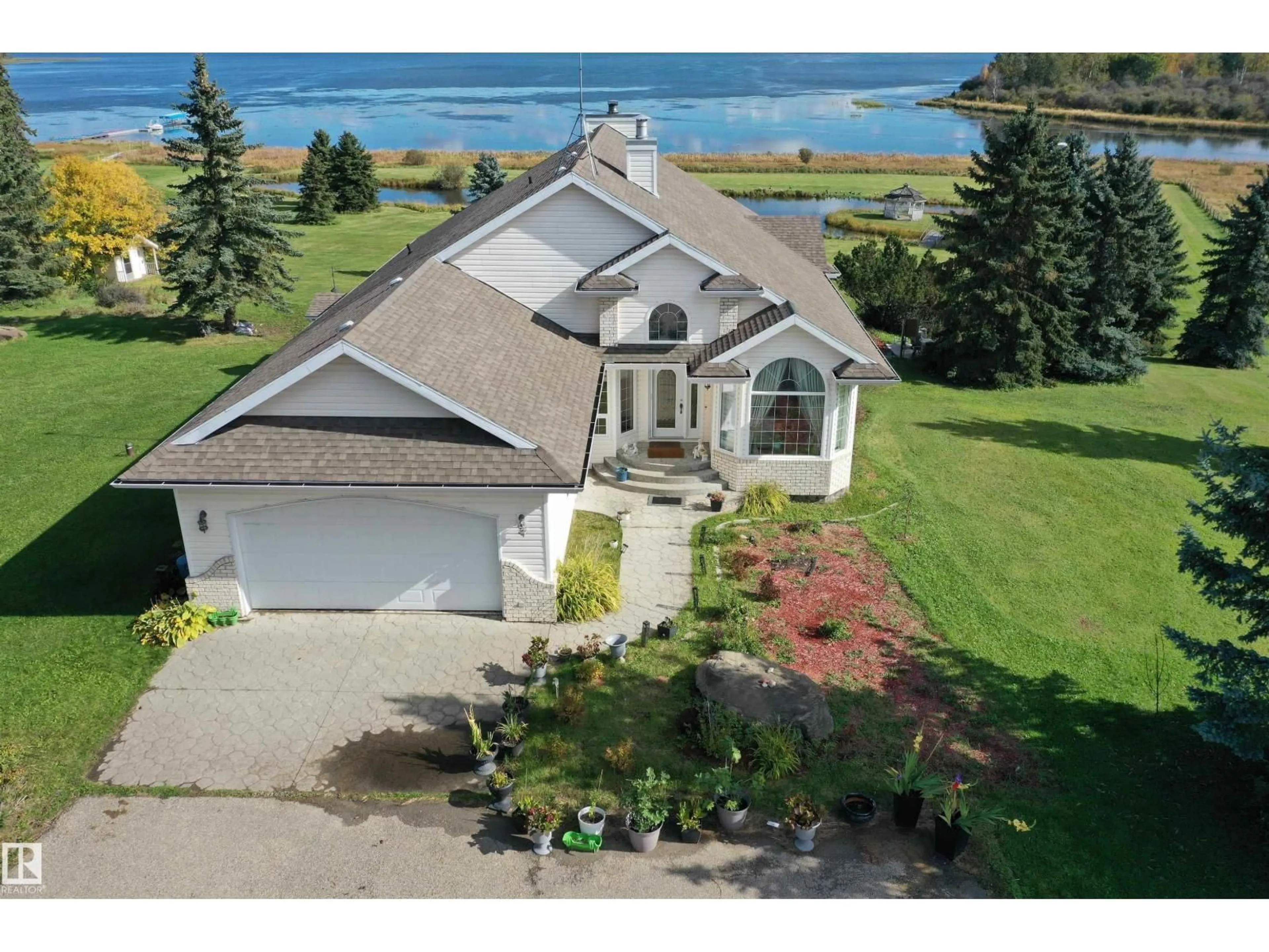 A pic from outside/outdoor area/front of a property/back of a property/a pic from drone, water/lake/river/ocean view for 205 1 AV, Rural Wetaskiwin County Alberta T0C0T0