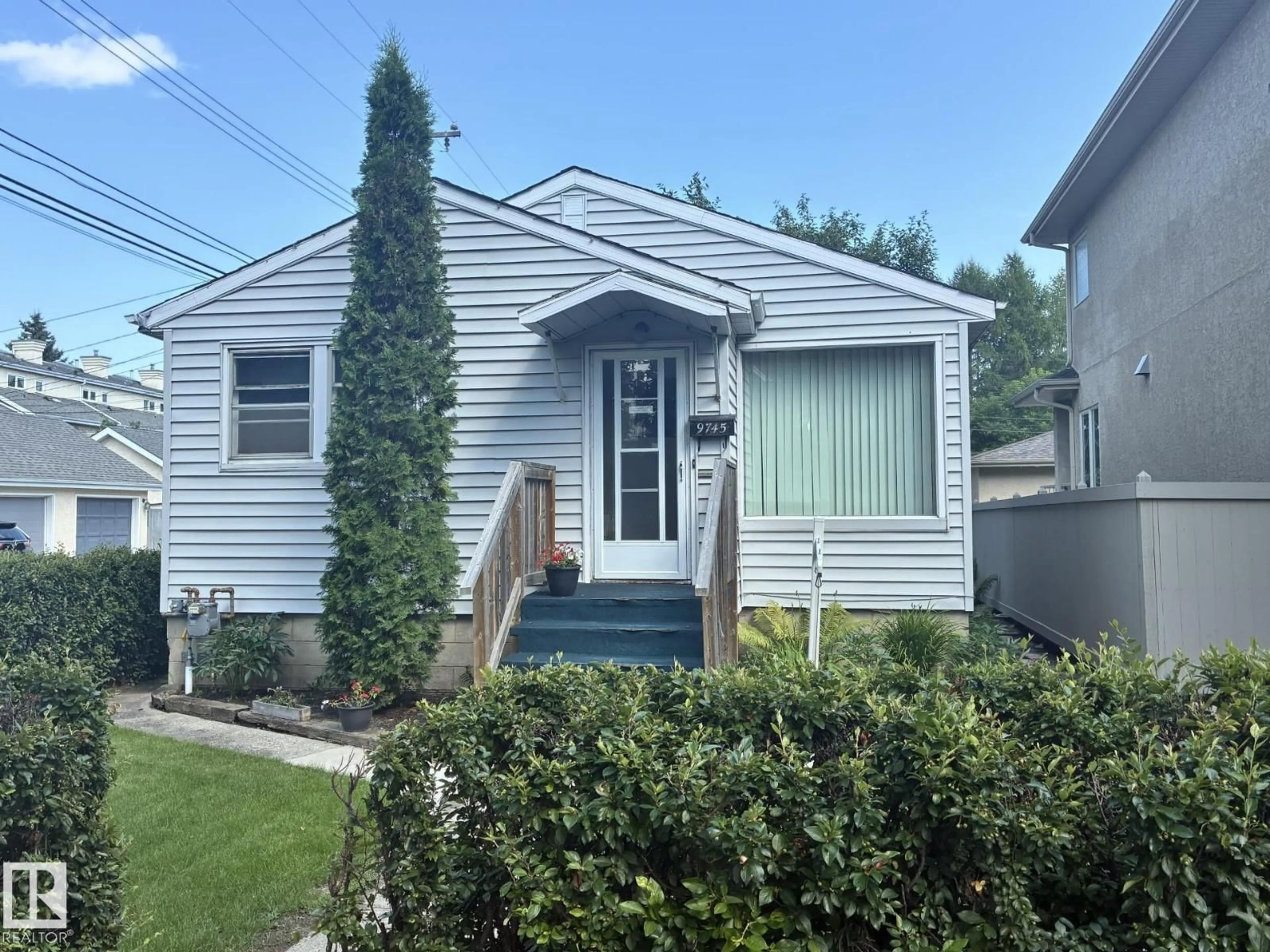 Home with vinyl exterior material, street for 9745 94 ST, Edmonton Alberta T6C3W1