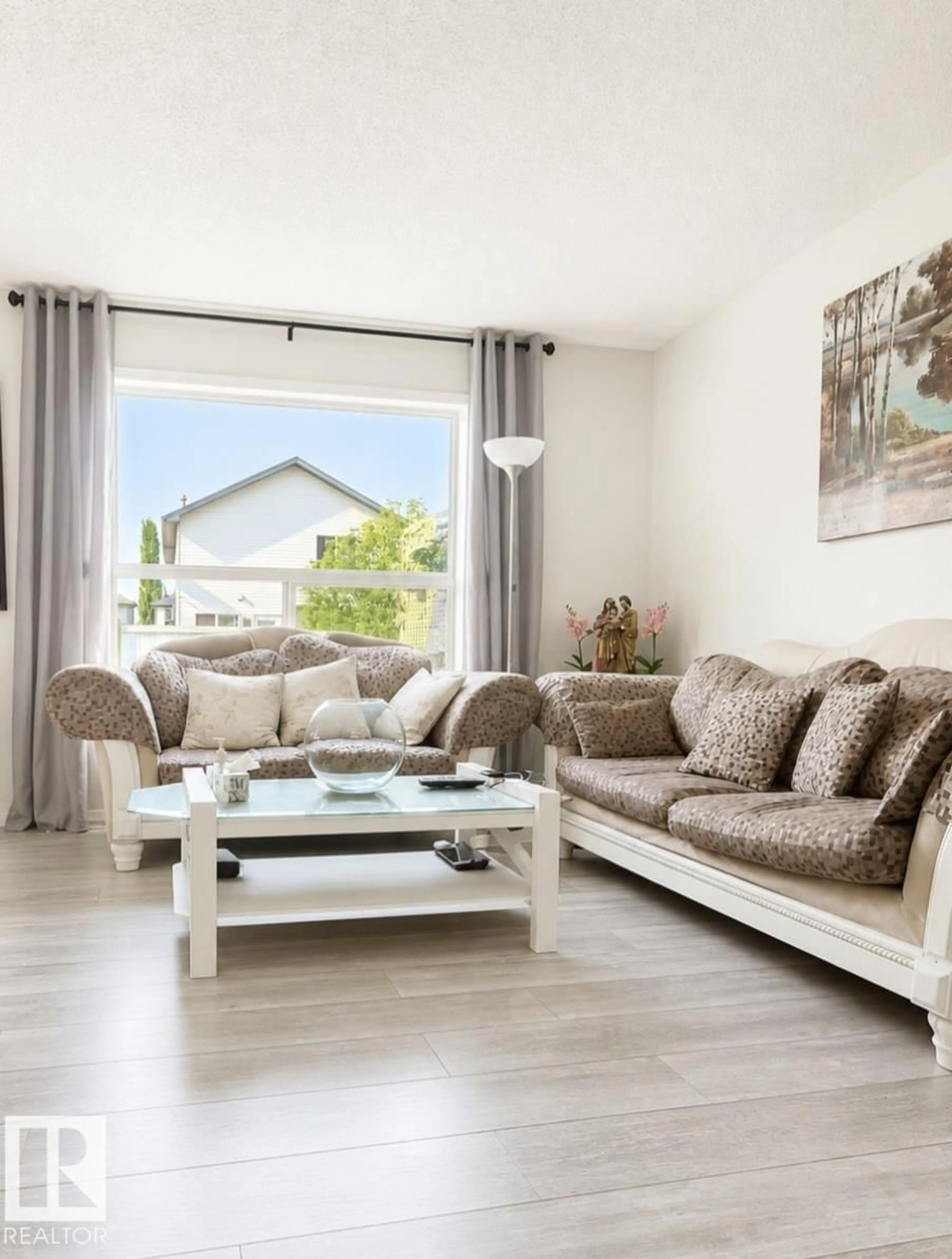 Living room with furniture, wood/laminate floor for 3236 27 AV, Edmonton Alberta T6T1P8